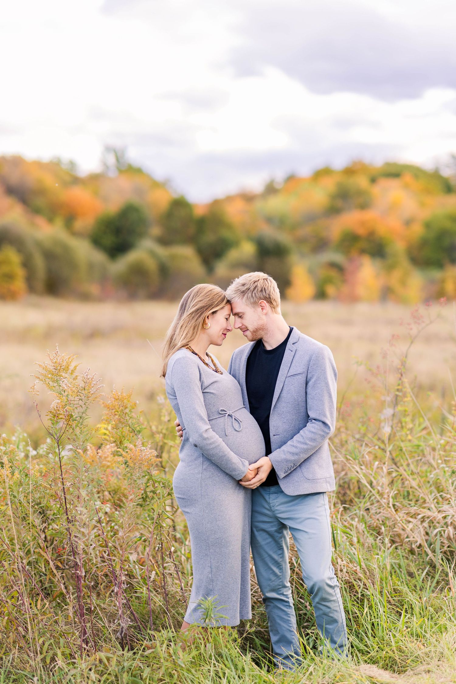 Couple embracing during a Connecticut maternity photography session outdoors — Minmo Photography