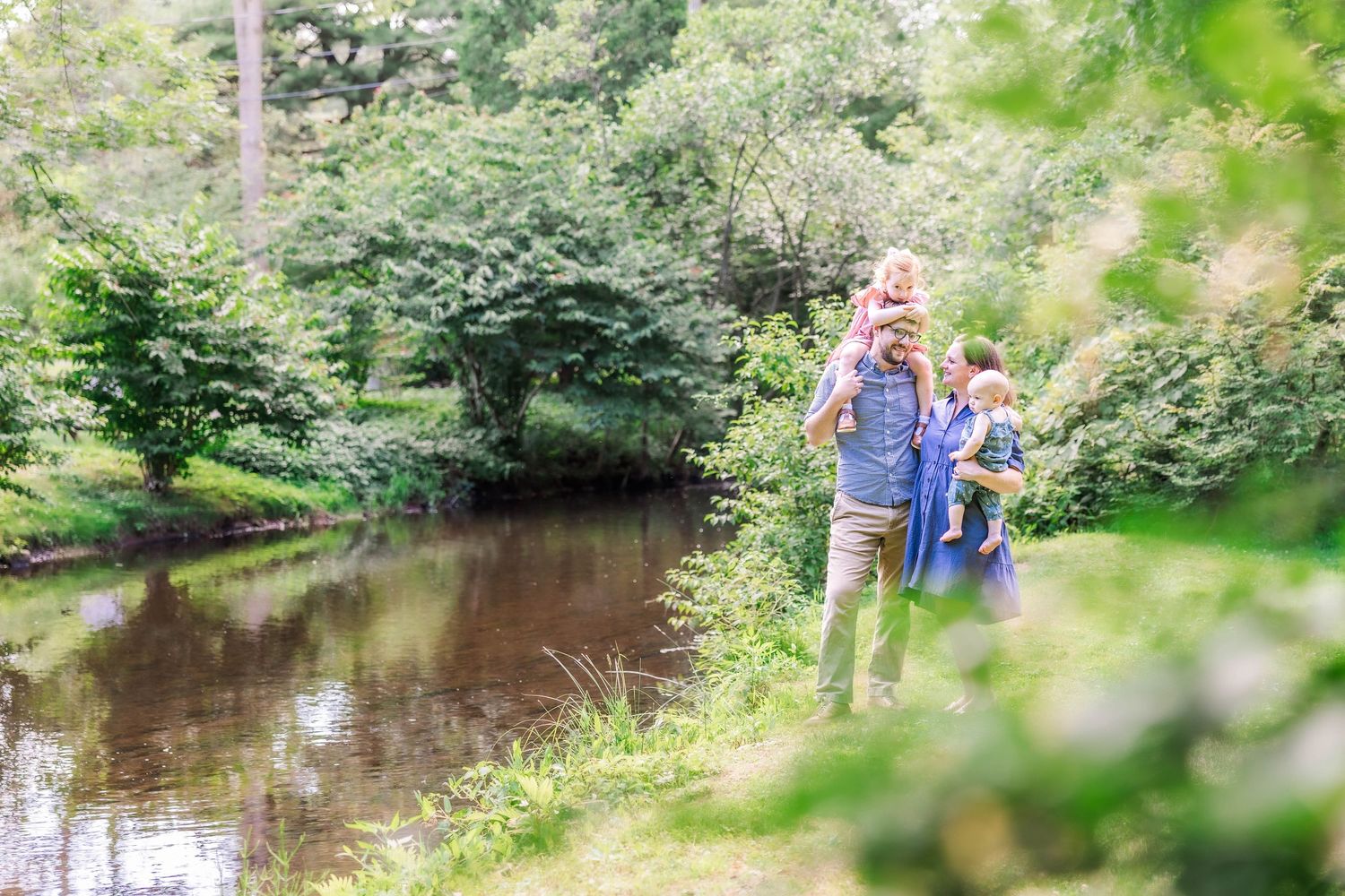 Family standing by the river during a Connecticut outdoor session — Minmo Photography