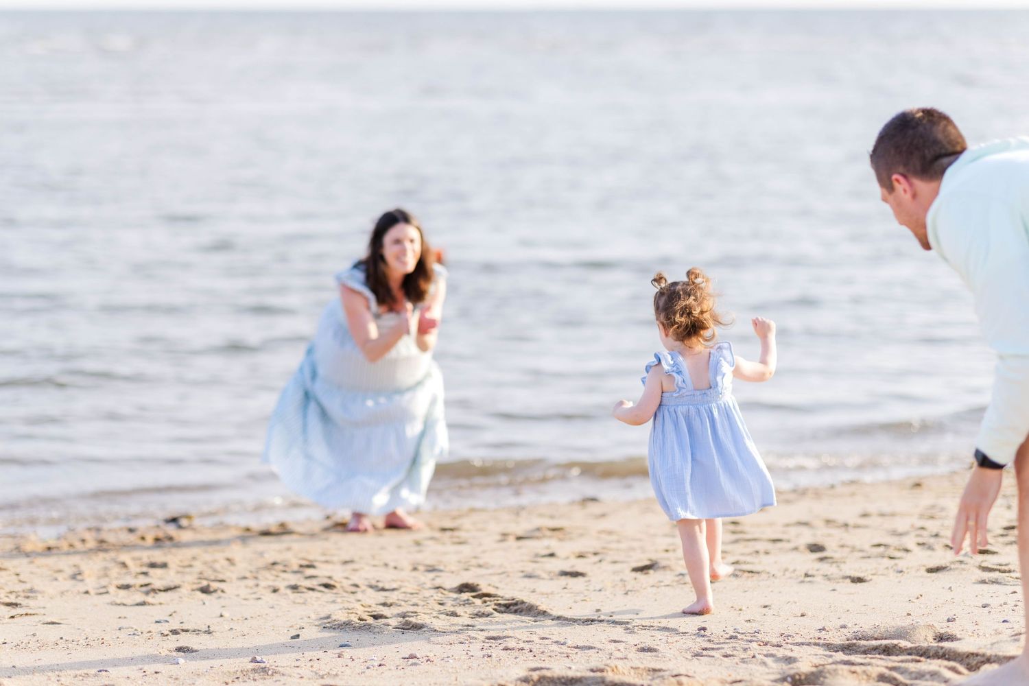 Little girl running to Mom during relaxed family photoshoot at the beach -- Minmo Photography