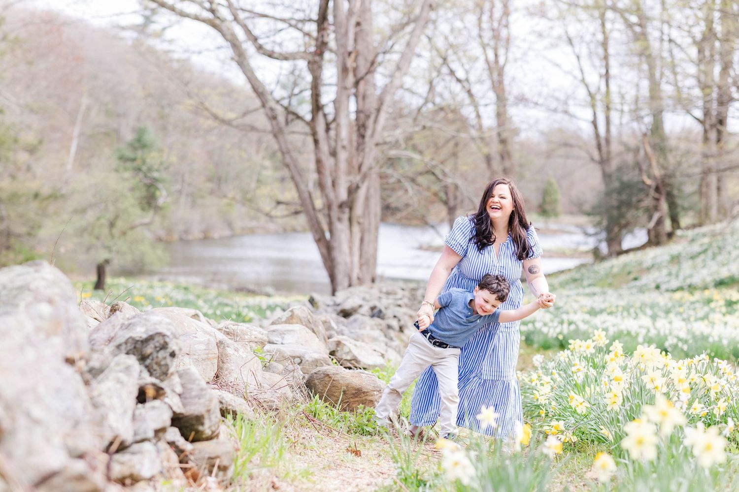 Mom and son playing among the daffodils during family photoshoot -- Minmo Photography