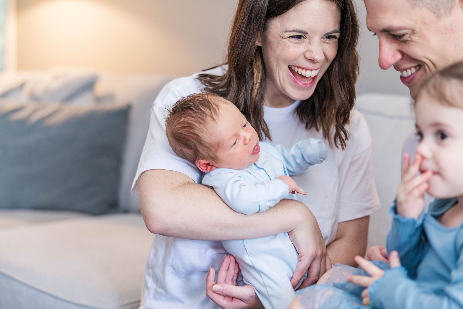 Parents cradling their newborn during a lifestyle newborn session in Connecticut — Minmo Photography