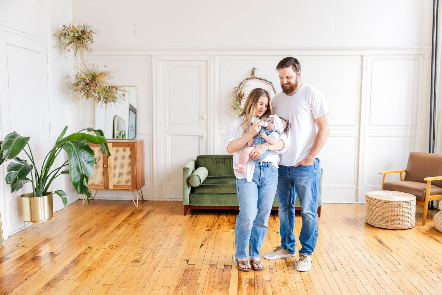 Parents feeding their newborn during a lifestyle newborn session in Connecticut at Gentle Bull Studios — Minmo Photography