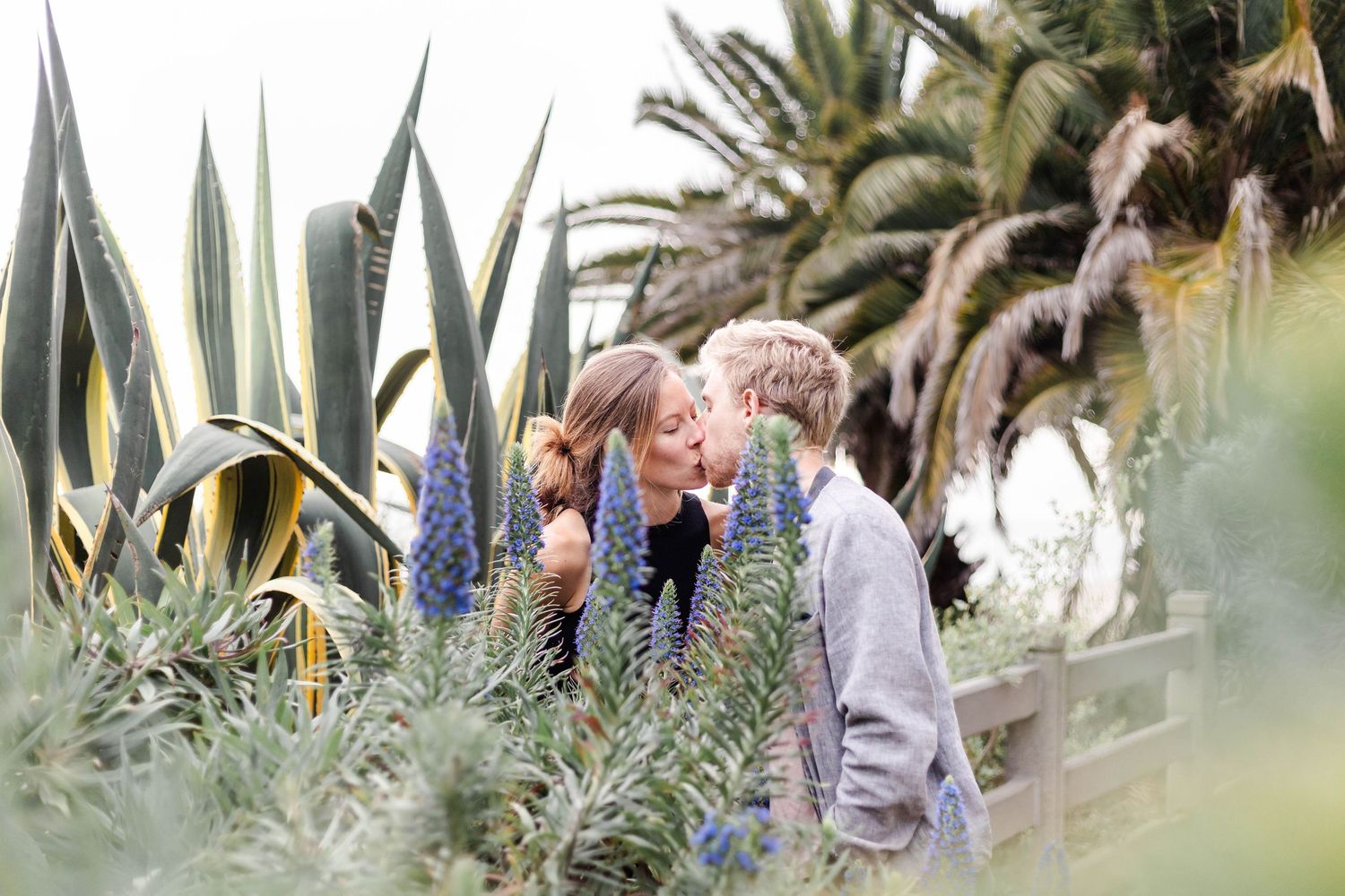 Couple embracing amid the flowers during a relaxed engagement session — Minmo Photography