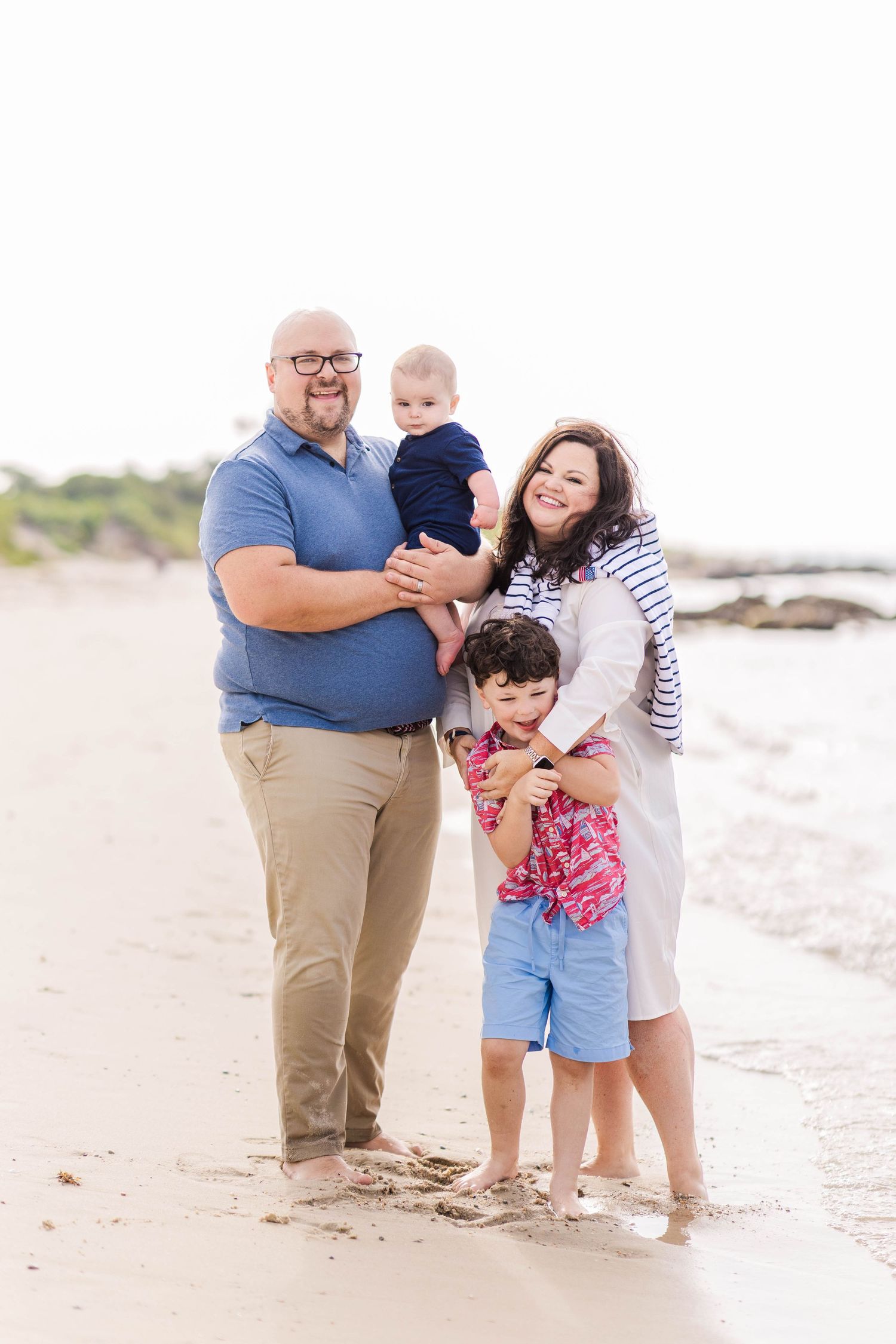 Family gathered at the edge of the water during a golden hour Connecticut outdoor session — Minmo Photography