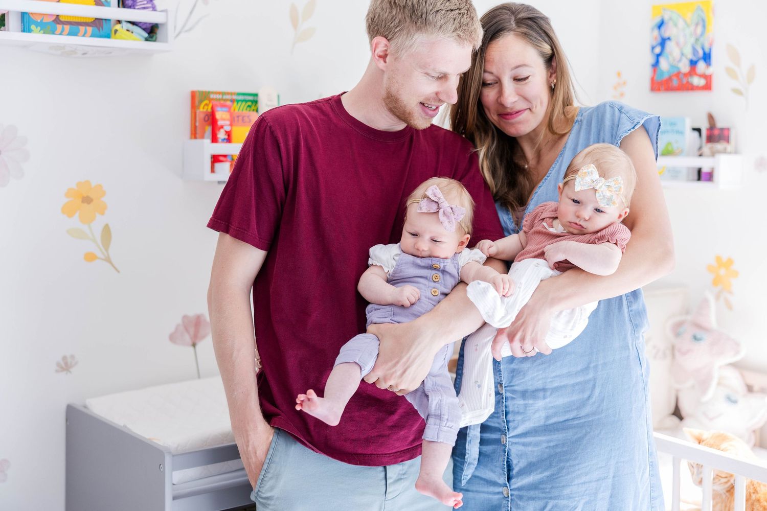 Parents holding their twins during a lifestyle newborn session at home — Minmo Photography