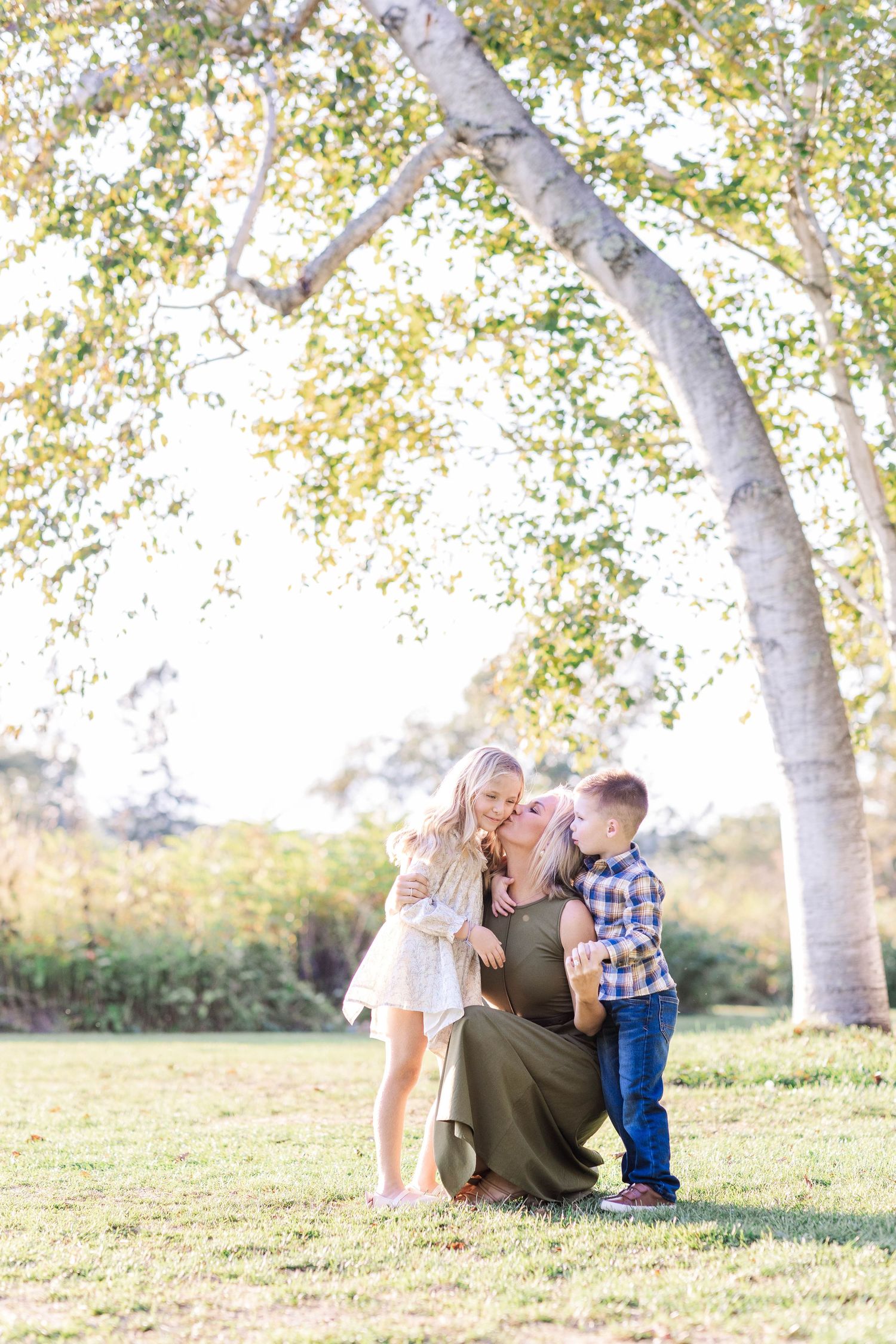 Mother snuggling her two children in natural light at Westmoor Park — Connecticut photographer Minmo Photography