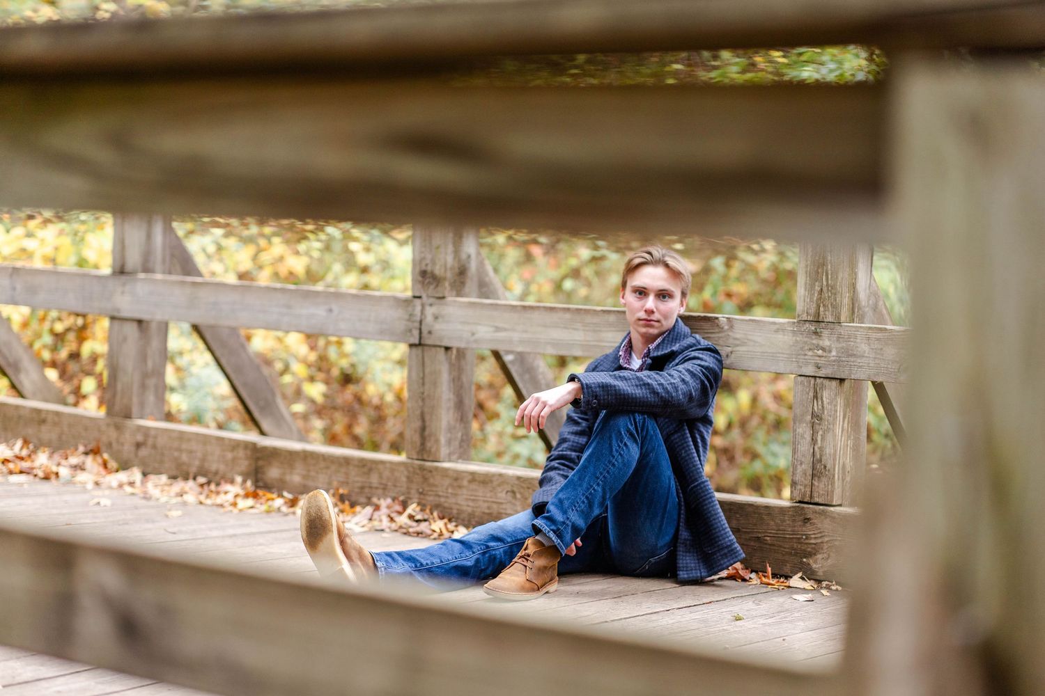 Senior portrait of a young man leaning against a bridge in Connecticut — Minmo Photography