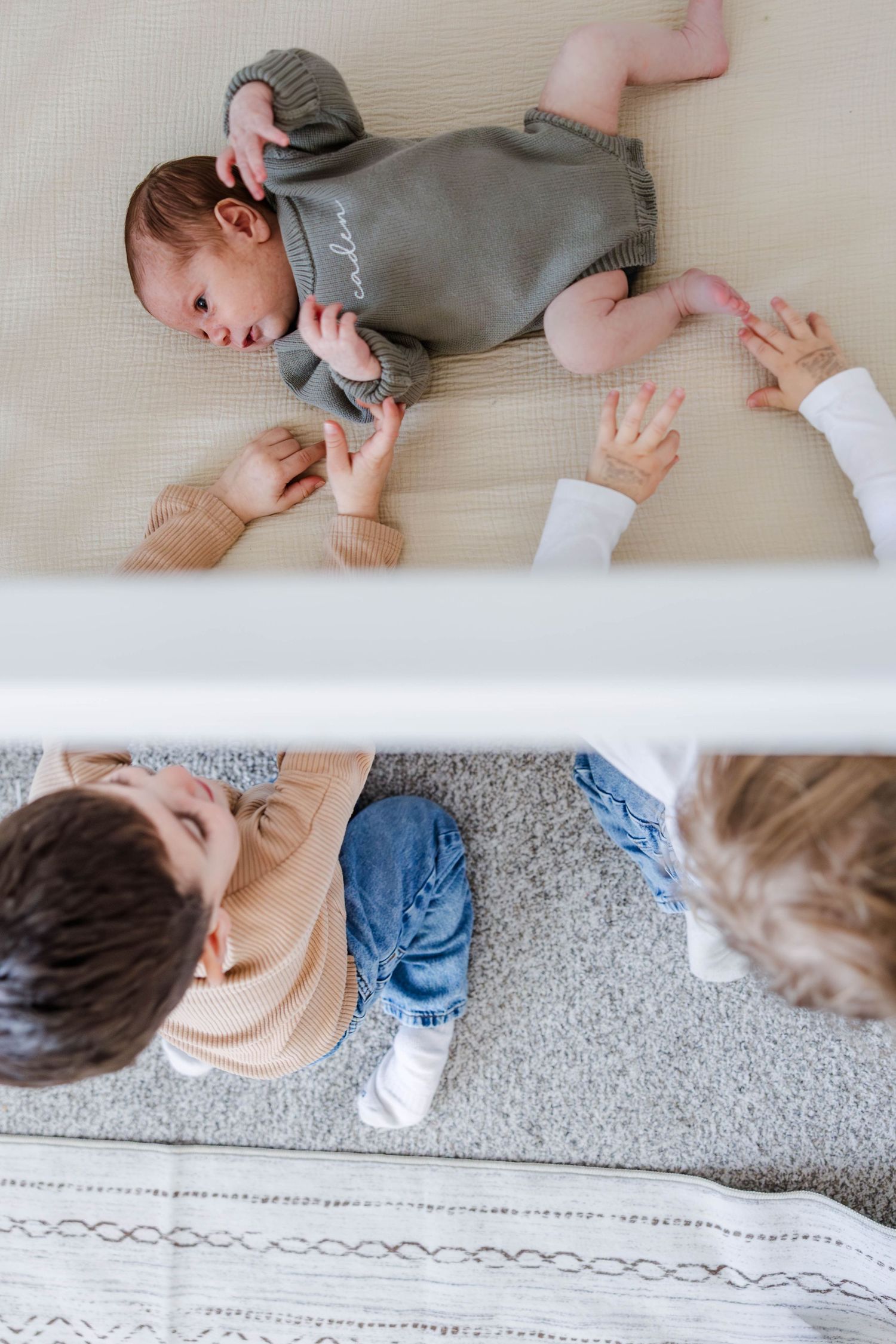 Big siblings looking at the new baby during a Connecticut newborn session — Minmo Photography