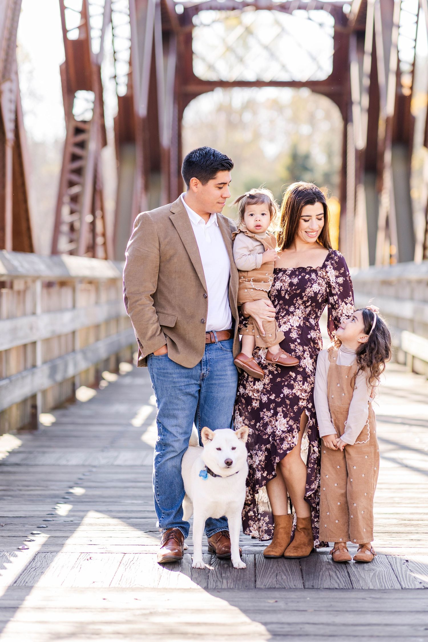 Family of four hugging on the Collinsville bridge during a fall family session — Minmo Photography