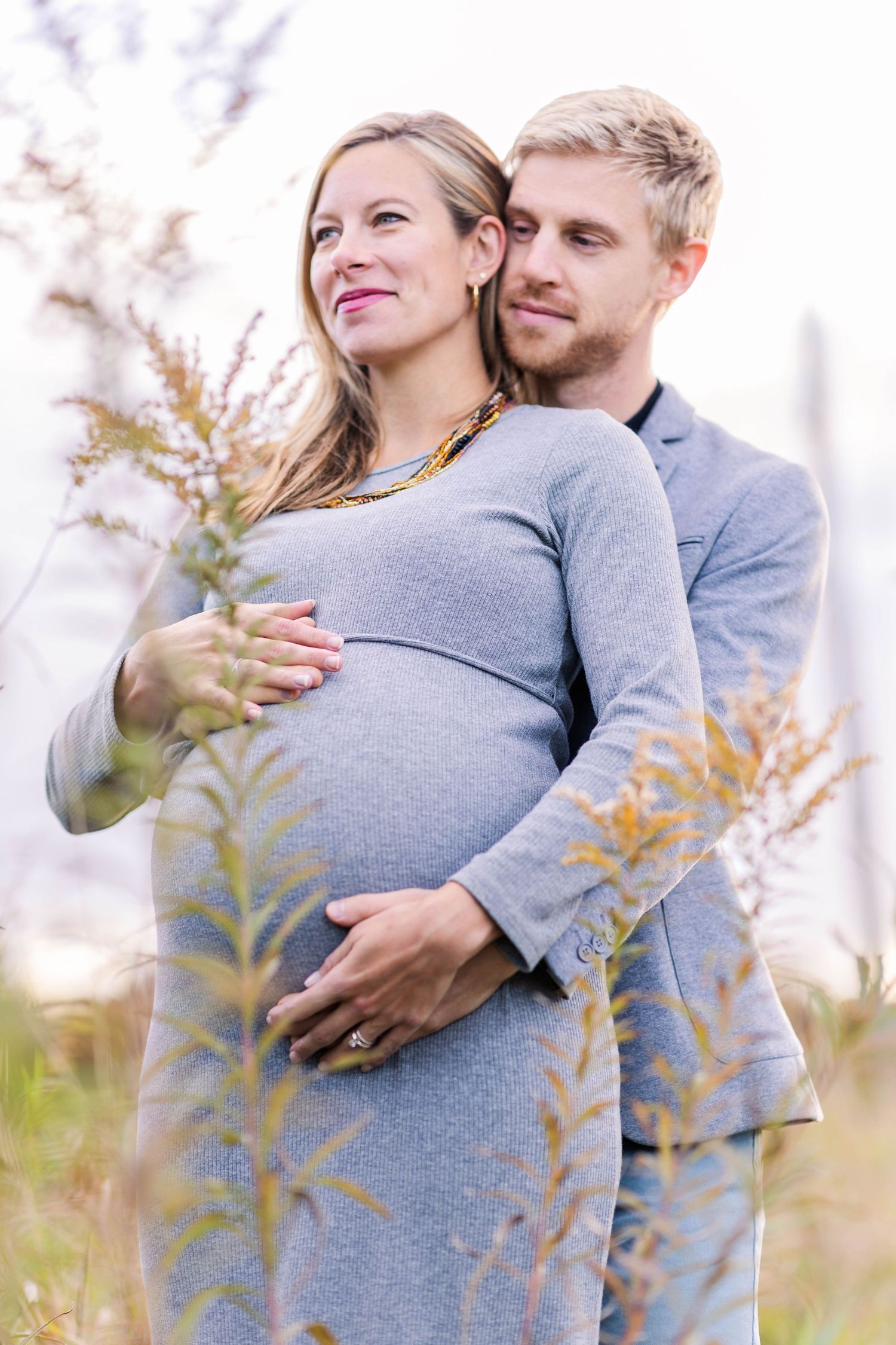 Couple embracing during a Connecticut maternity photography session outdoors — Minmo Photography
