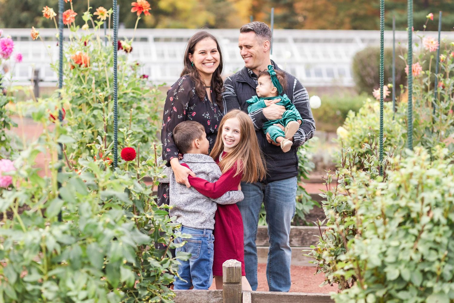 Family surrounded by flowers at Elizabeth Park during photo session — Minmo Photography