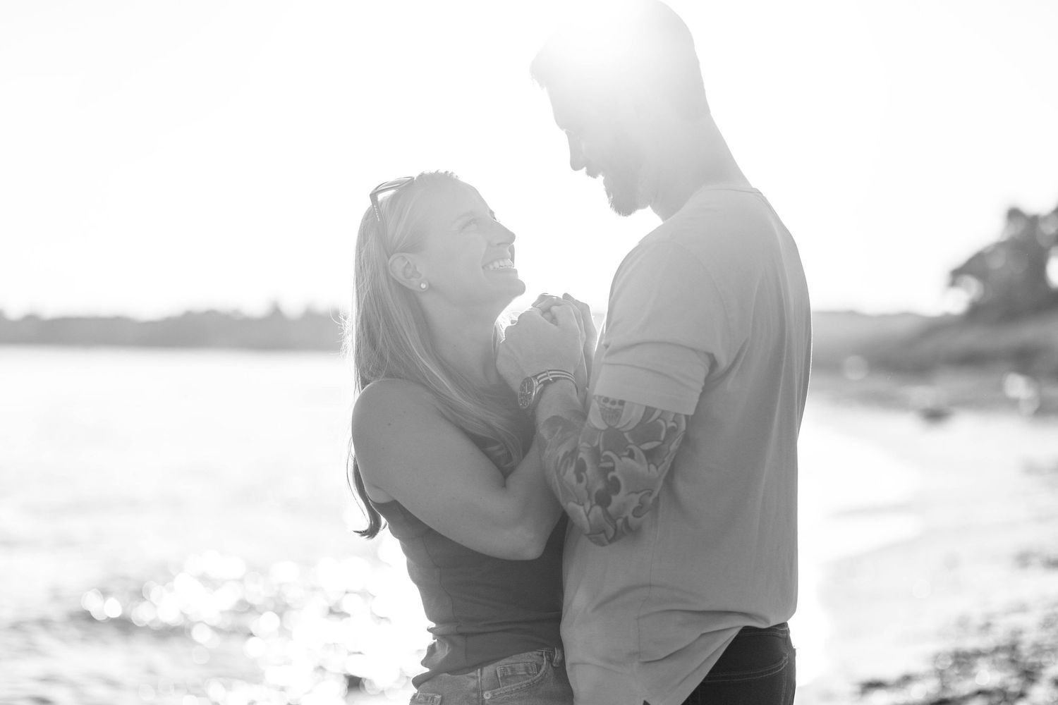 Engaged couple holding hands during a Connecticut engagement session at the beach — Minmo Photography