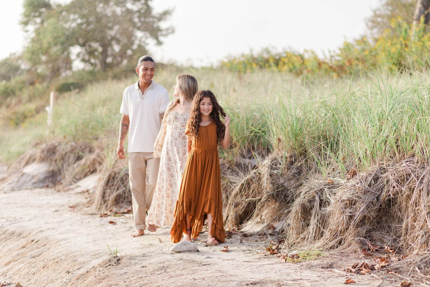 Family walking along the sand dunes at the beach during photo session -- Minmo Photography