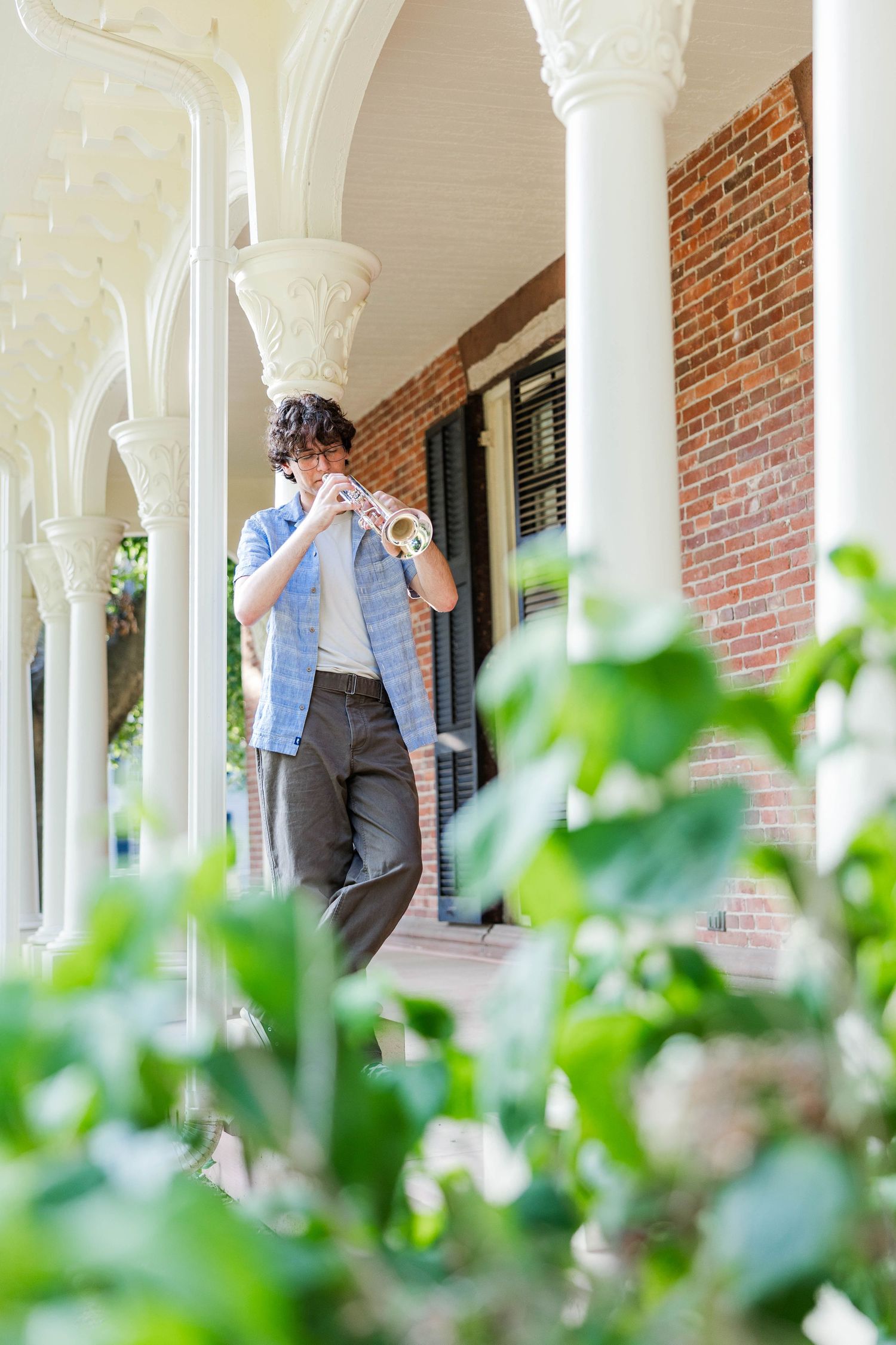 Senior portrait of a young man leaning against a brick wall in Connecticut — Minmo Photography