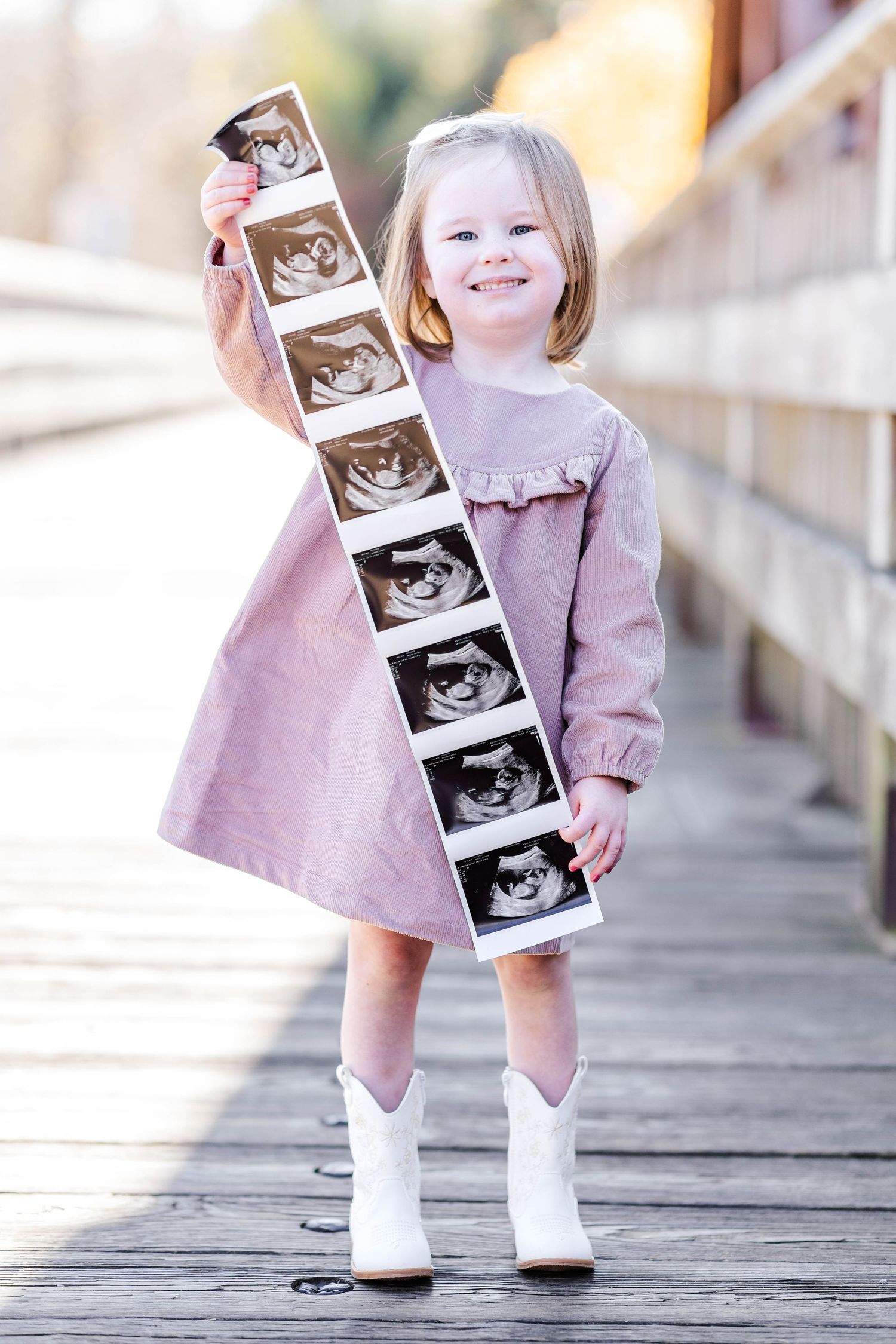 Family maternity session with toddler showing off ultrasound photos — Connecticut maternity photographer Minmo Photography