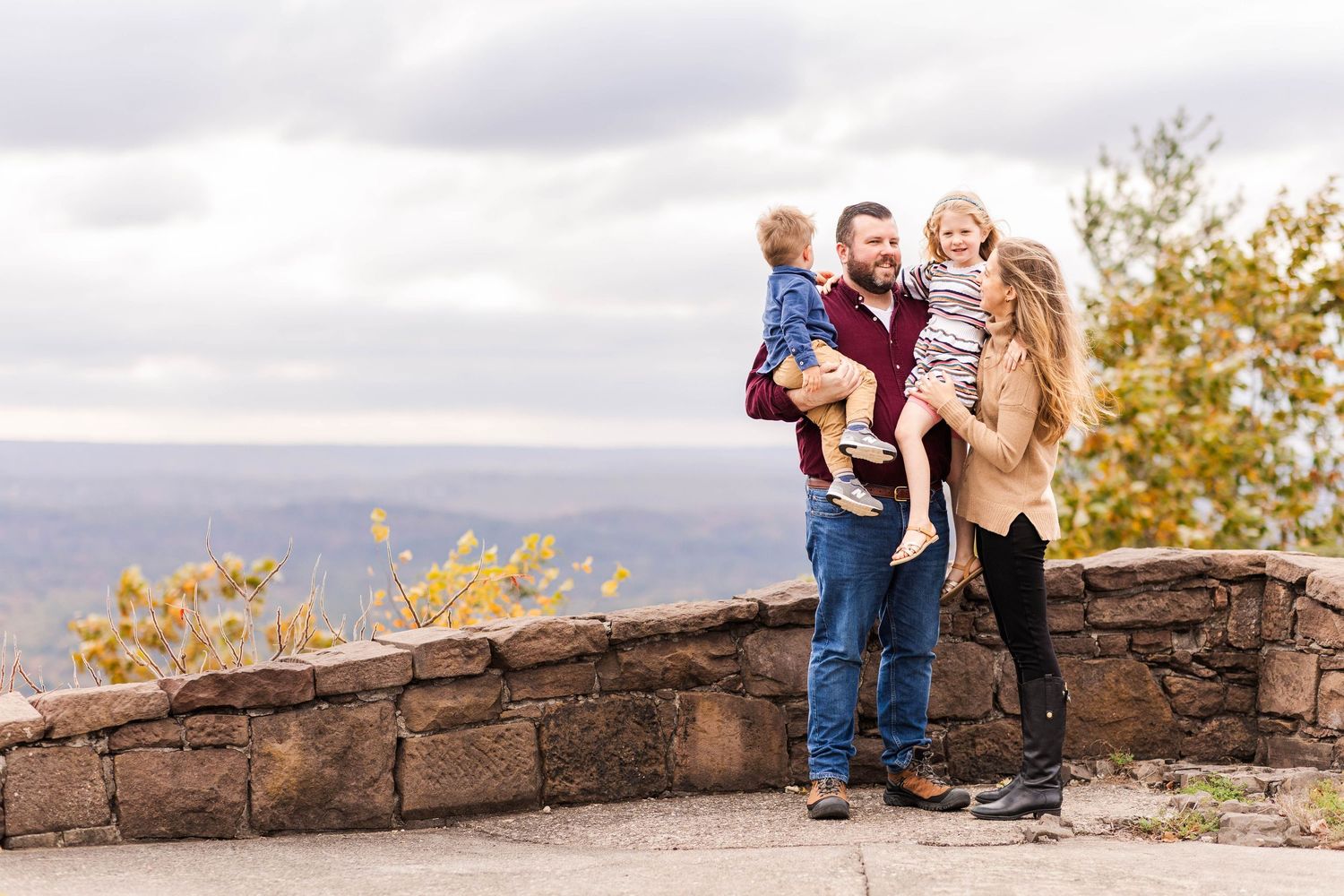 A family of four at an overlook of the Farmington Valley during a fall family photoshoot — Minmo Photography