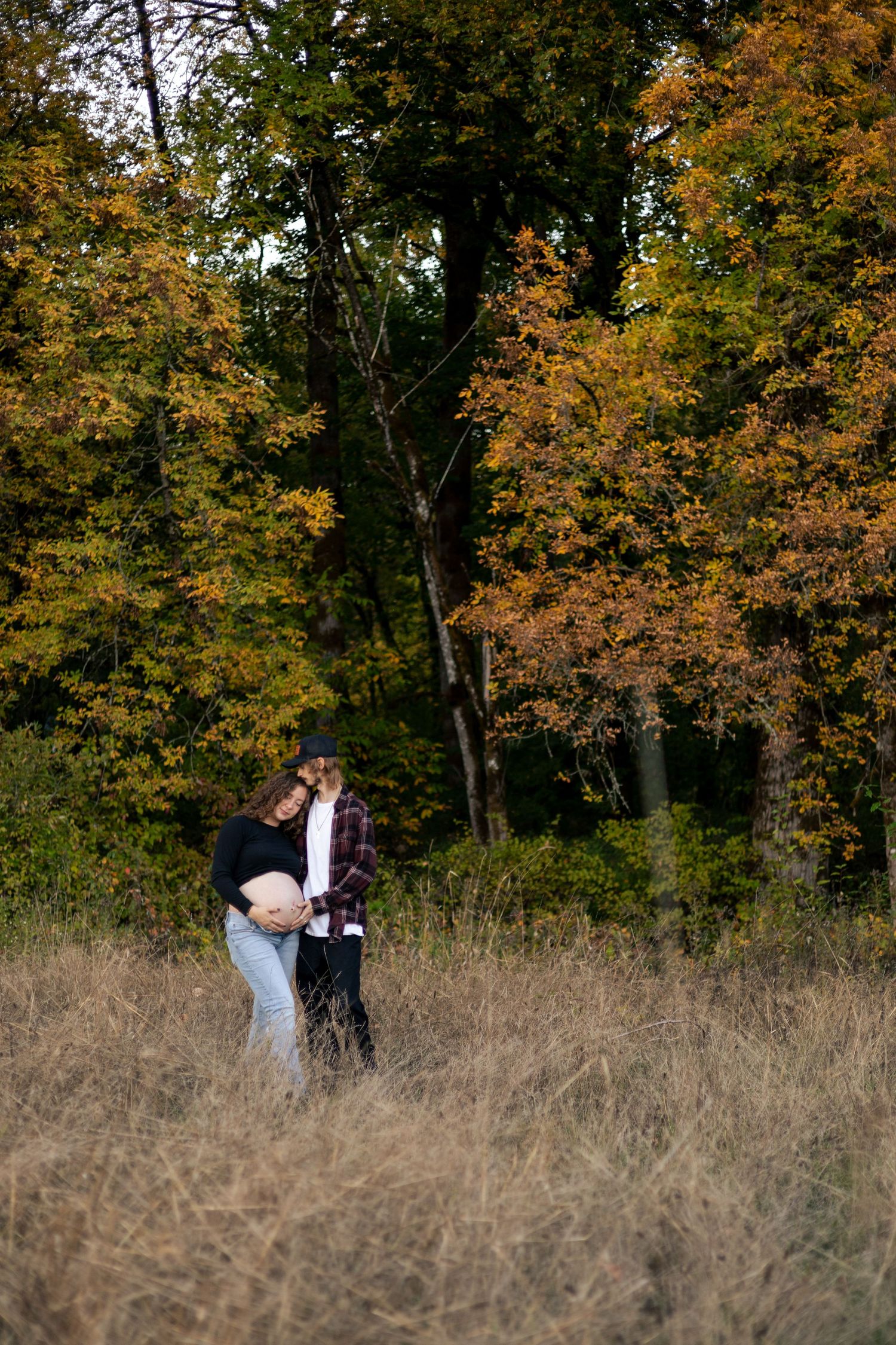 Maternity couples session with fall trees in Idaho