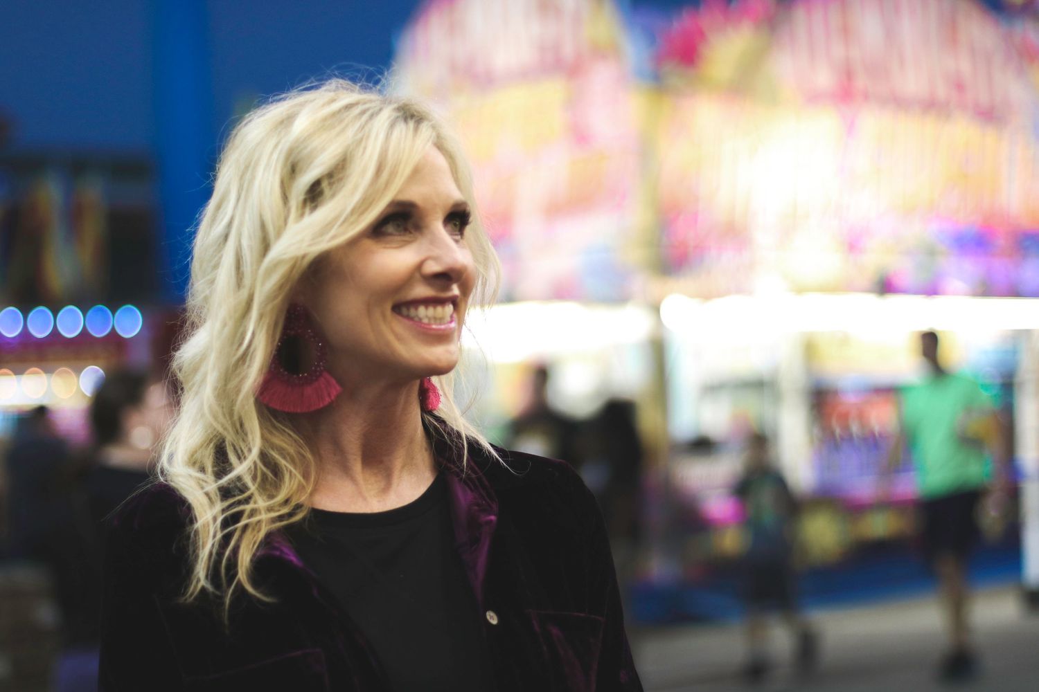 Colorful carnival at night with bright neon lights and festive atmosphere.