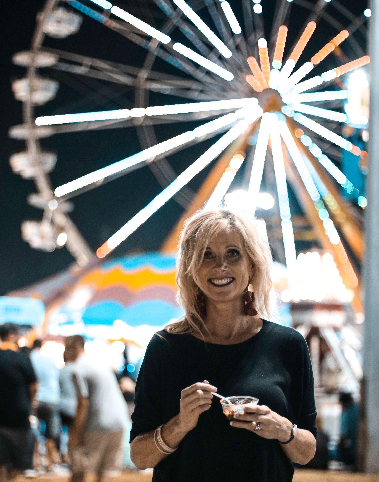 Nighttime carnival scene with bright starburst lights creating a magical ambiance.