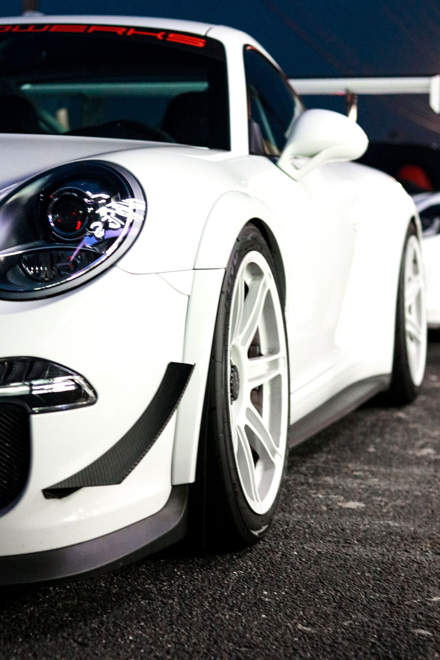 Close-up detail shots of a white sports car's exterior panels and headlights.