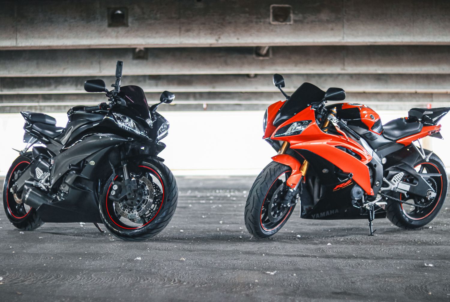Series of Yamaha motorcycles arranged in a line inside a parking structure.