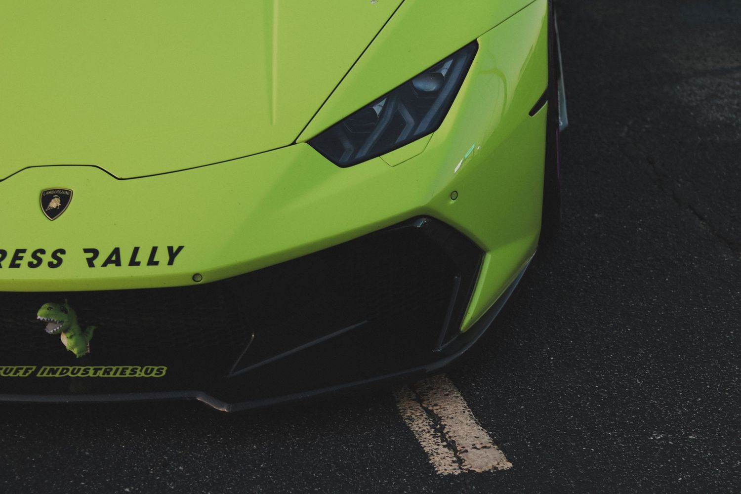 Front quarter view of a bright green Lamborghini with custom rally-style modifications.