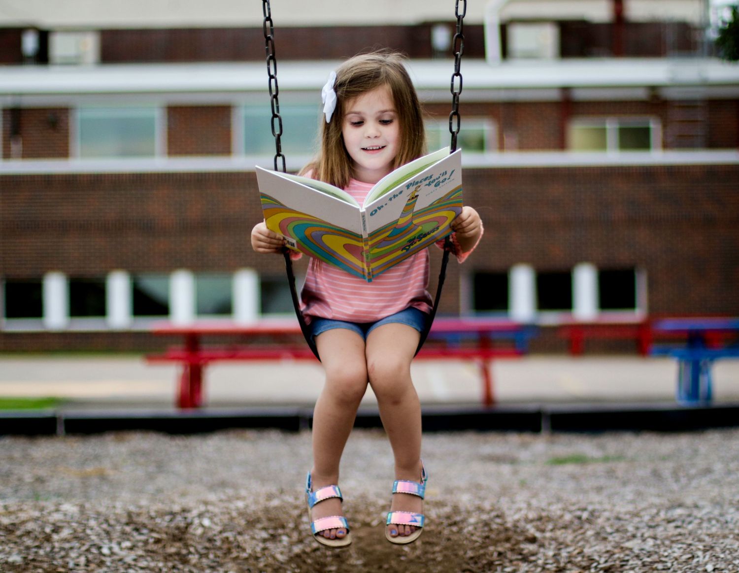 A sequence of photos showing a child swinging at a playground.