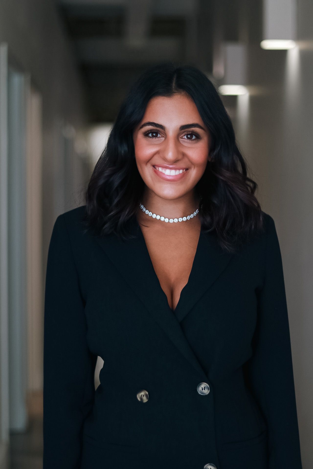 Professional headshots showing someone in a black blazer and pearl necklace.