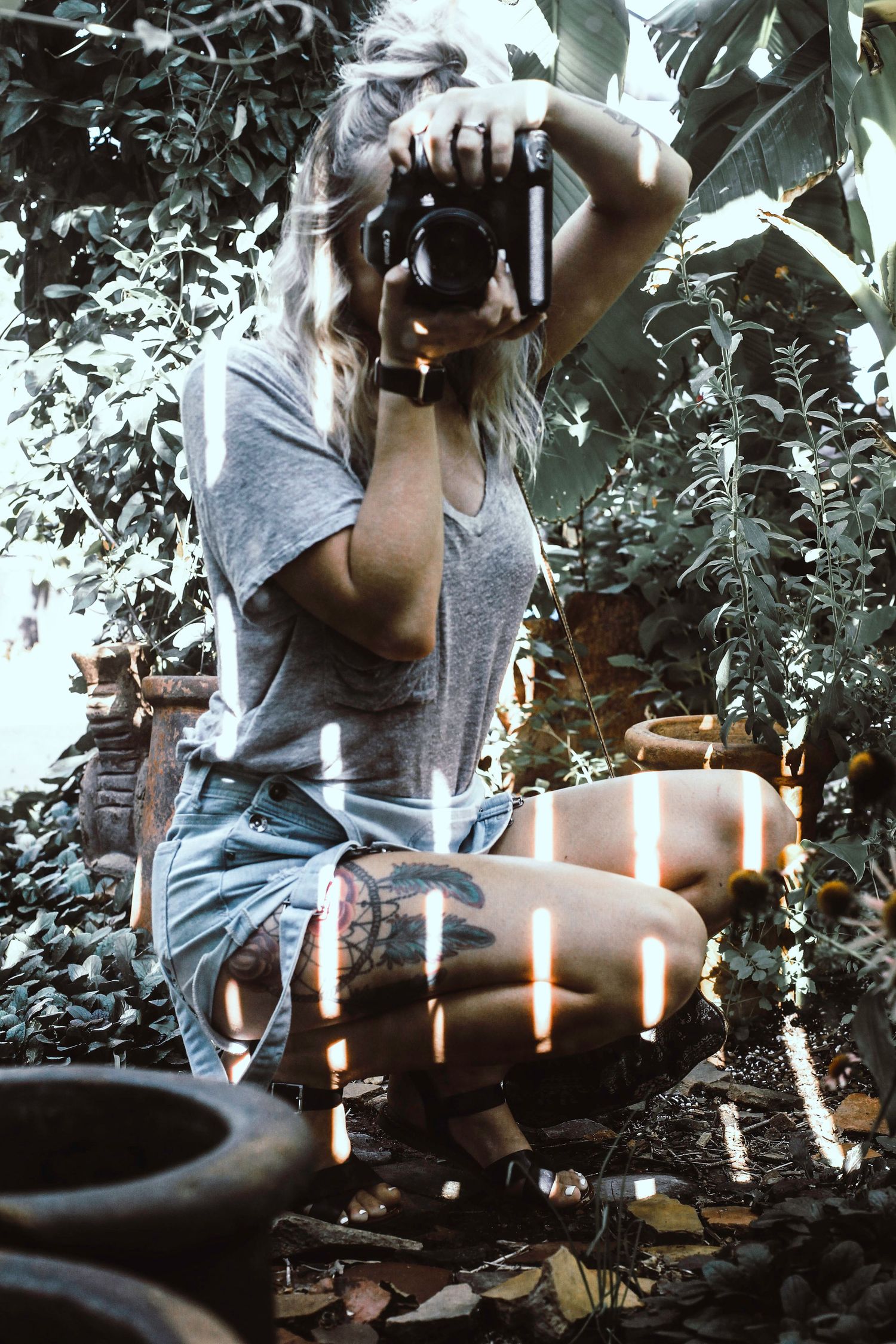Atmospheric scene with candles and plants creating moody lighting effects.