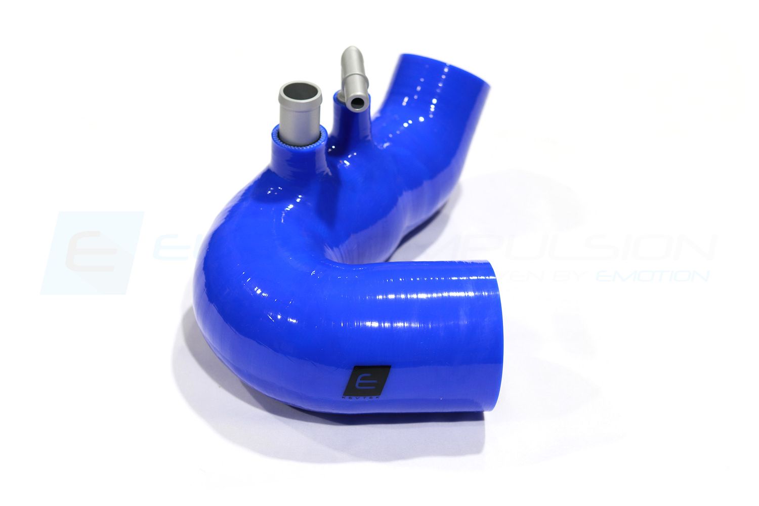 Blue silicone hose connectors and fittings laid out in a row on white background.