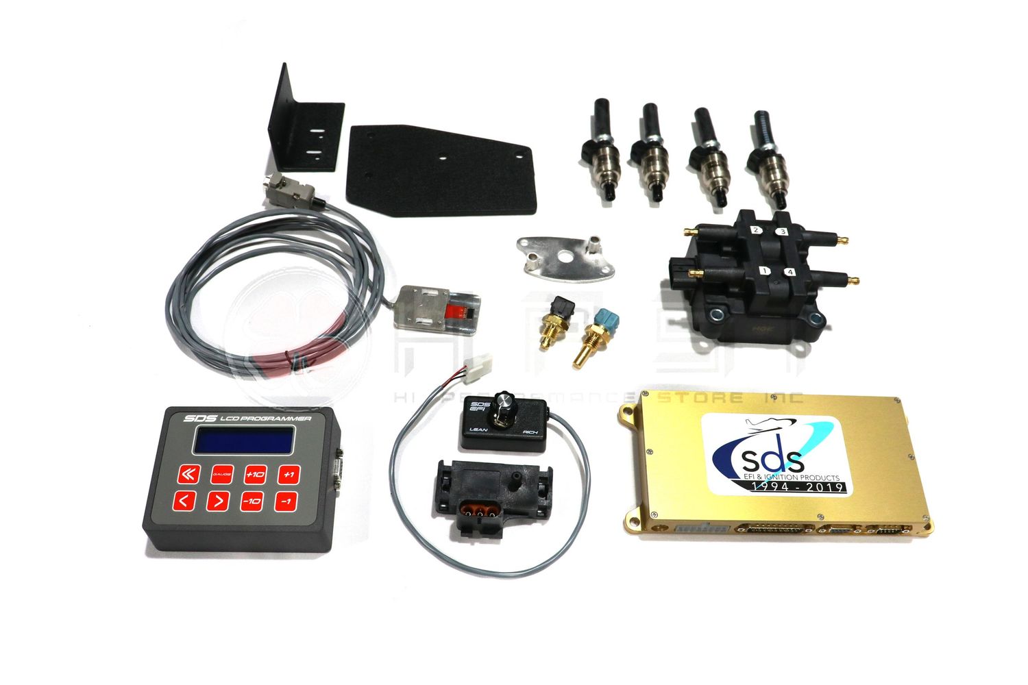 Various automotive sensors, gauges, and electronic components laid out on a white background for display.