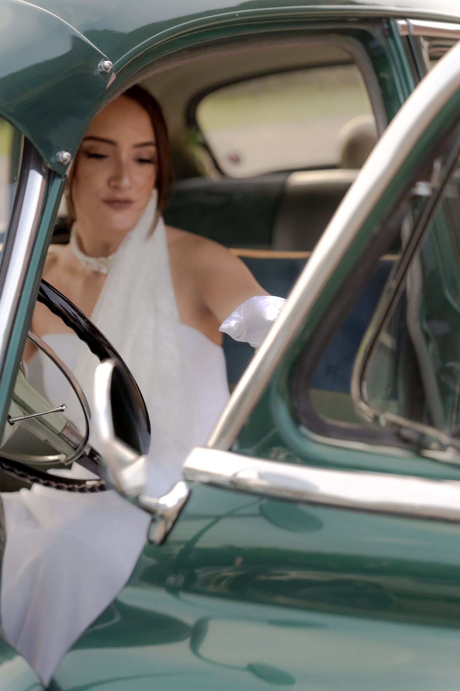 Bride in a vintage car closing the door in Belle River Minnesota