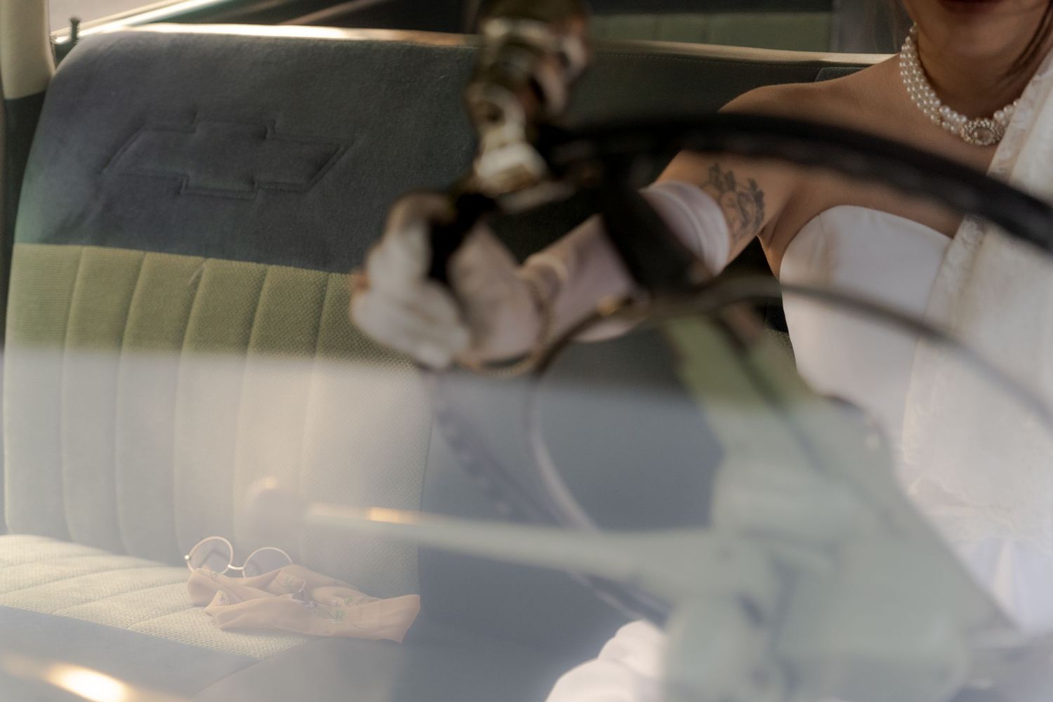 Cinematic shot of a bride driving a vintage car in Belle River Minnesota