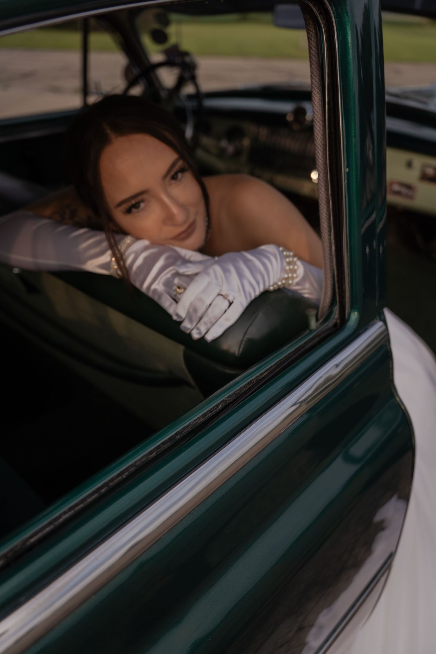 Cinematic shot of a bride driving a vintage car in Belle River Minnesota