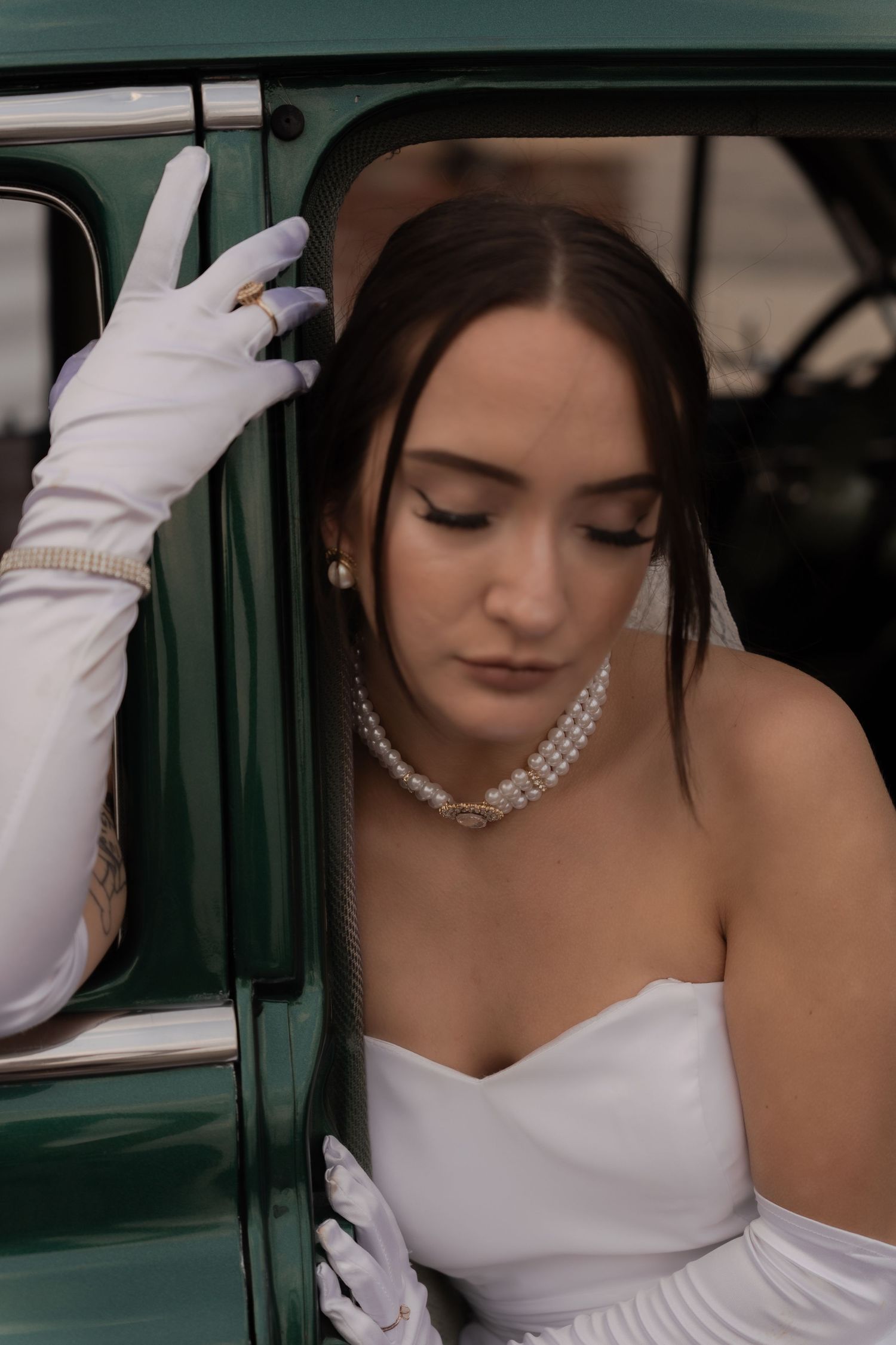 Cinematic shot of a bride driving a vintage car in Belle River Minnesota