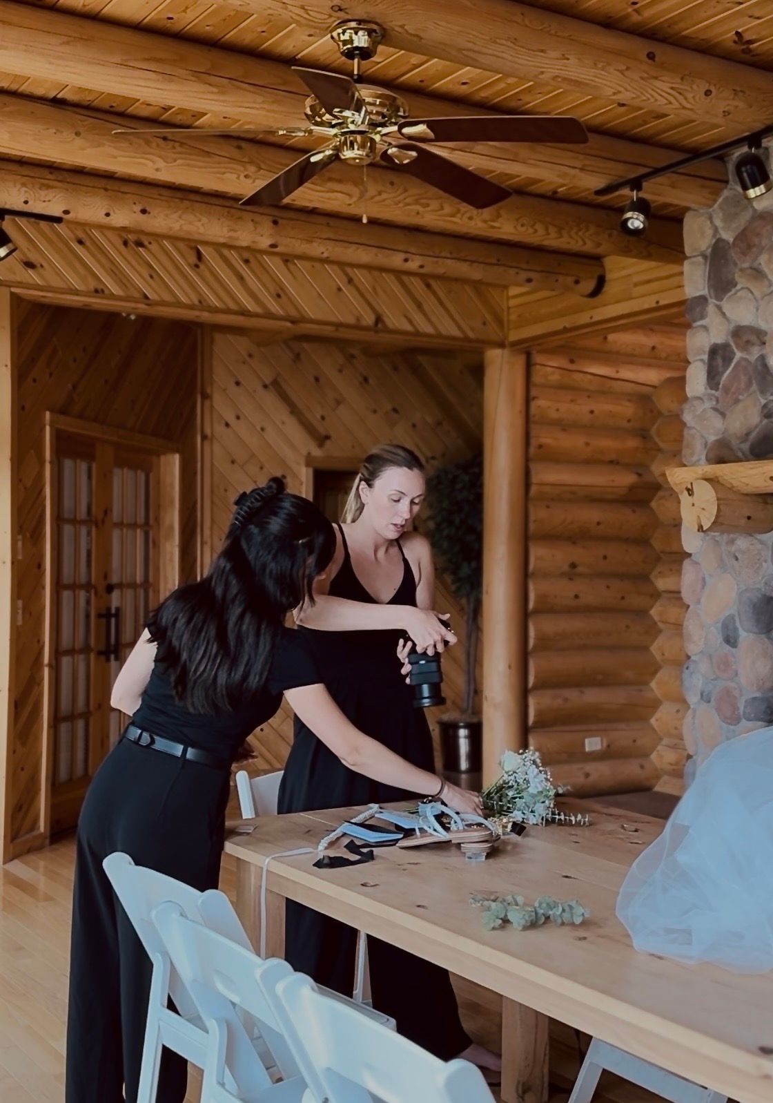 A photo of the owner of Coley Rose Co. assisting another photographer with detail shots at Northern Oaks Wedding venue in Minnesota.