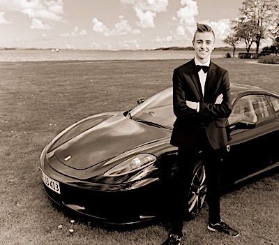 Classic black luxury car photographed in dramatic sepia tones on an open field.