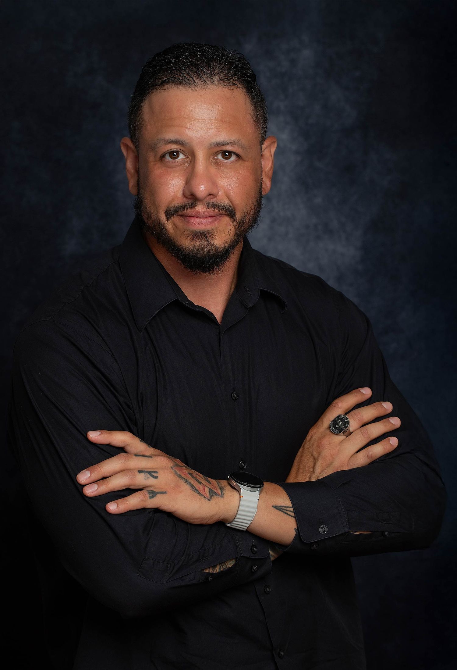Series of expressive poses in black formal shirt against dark studio background.