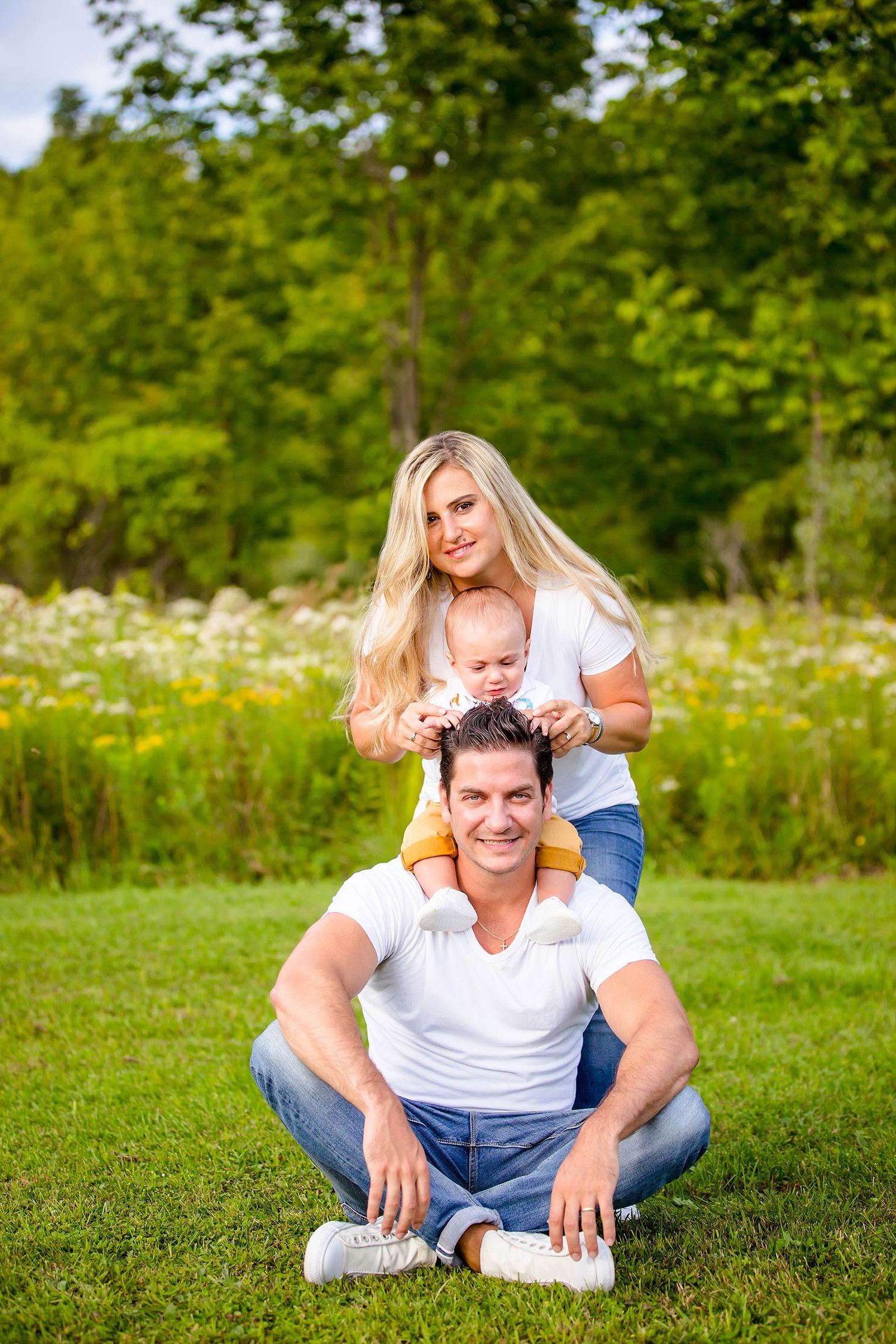 Couple enjoying a sunny day together in a meadow with wildflowers.