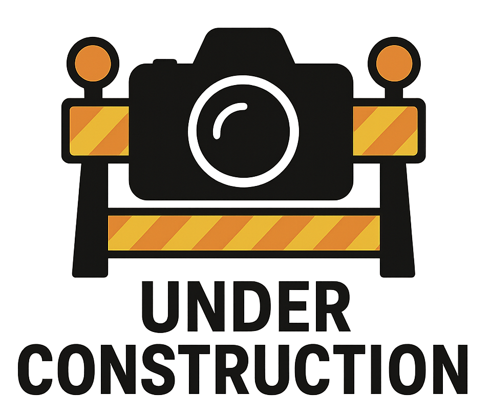 A simple black camera icon with construction barrier graphic and text.