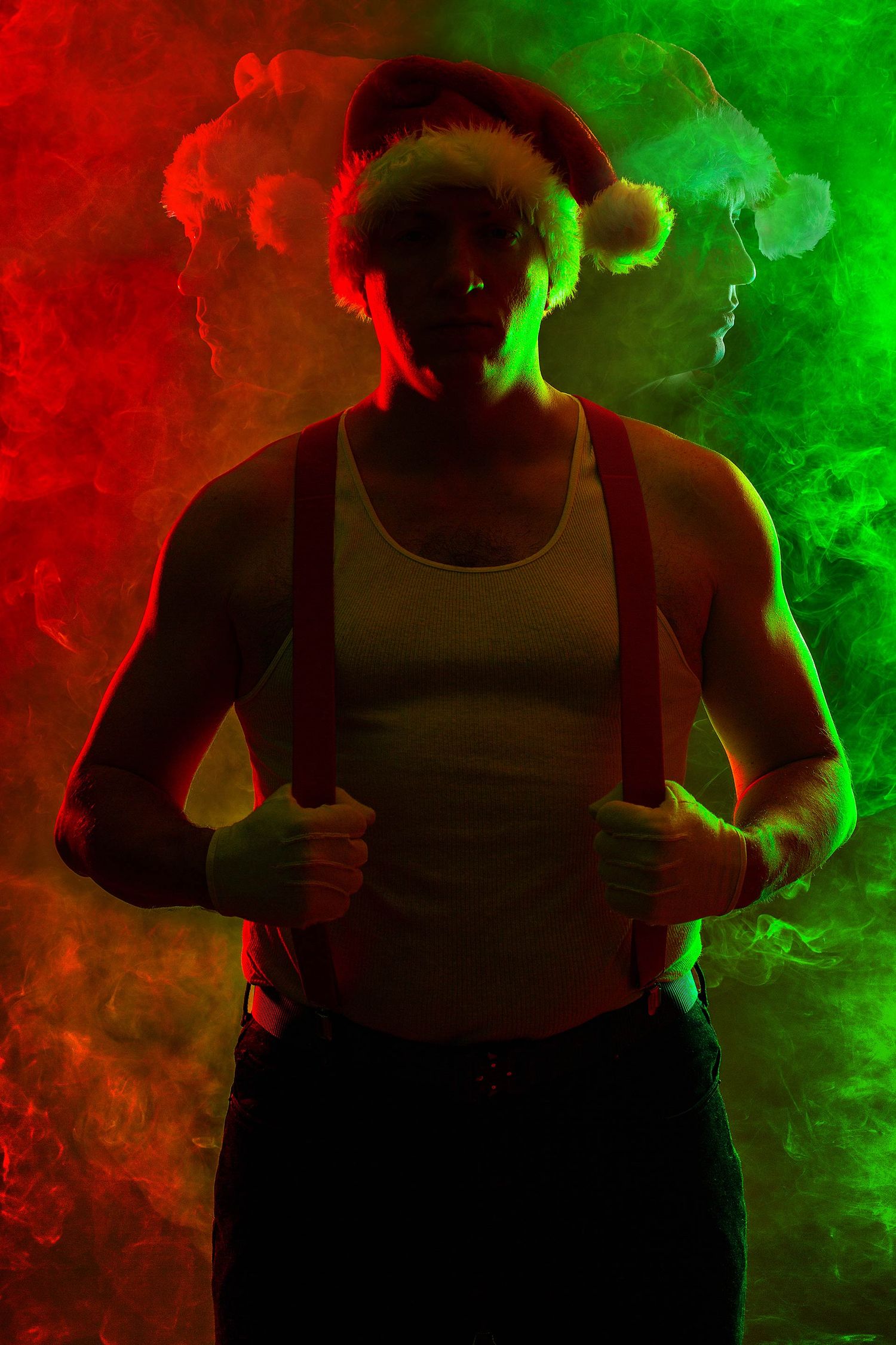 Silhouetted figure in tank top surrounded by dramatic red and green smoke effects.