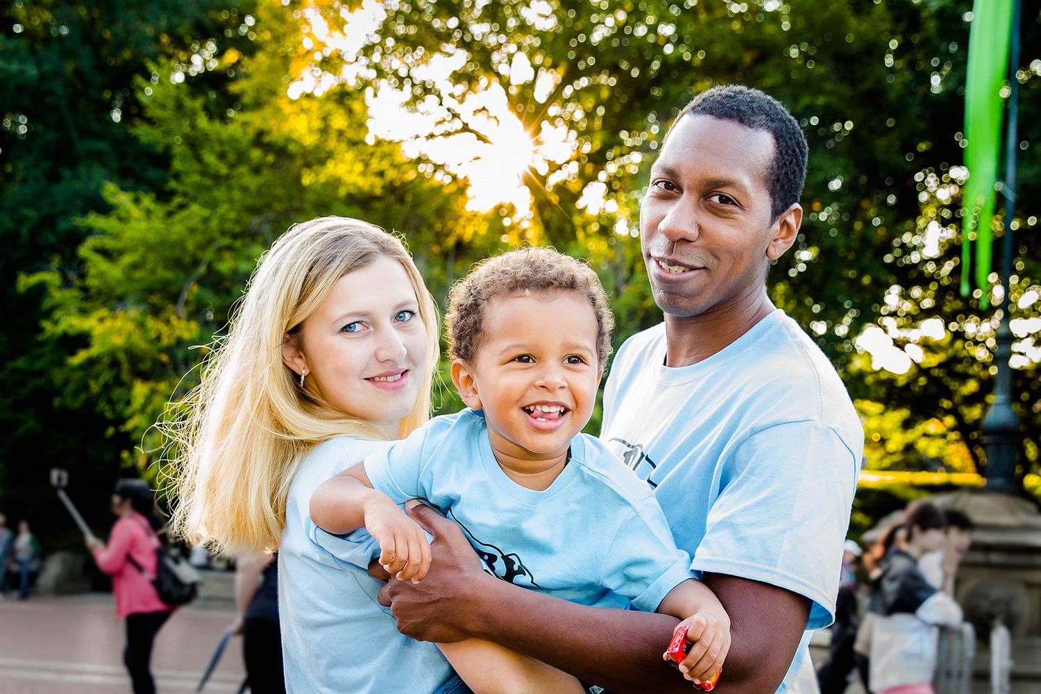 Candid family moments captured in a park setting at sunset.