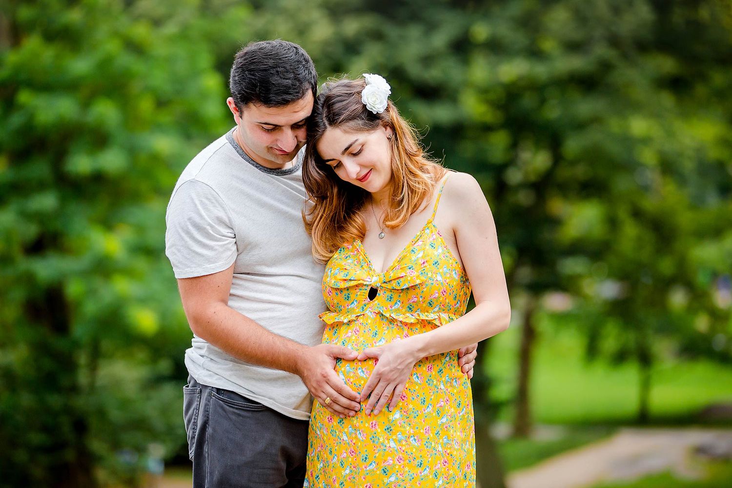 Romantic outdoor photoshoot with couple in yellow dress and white shirt.