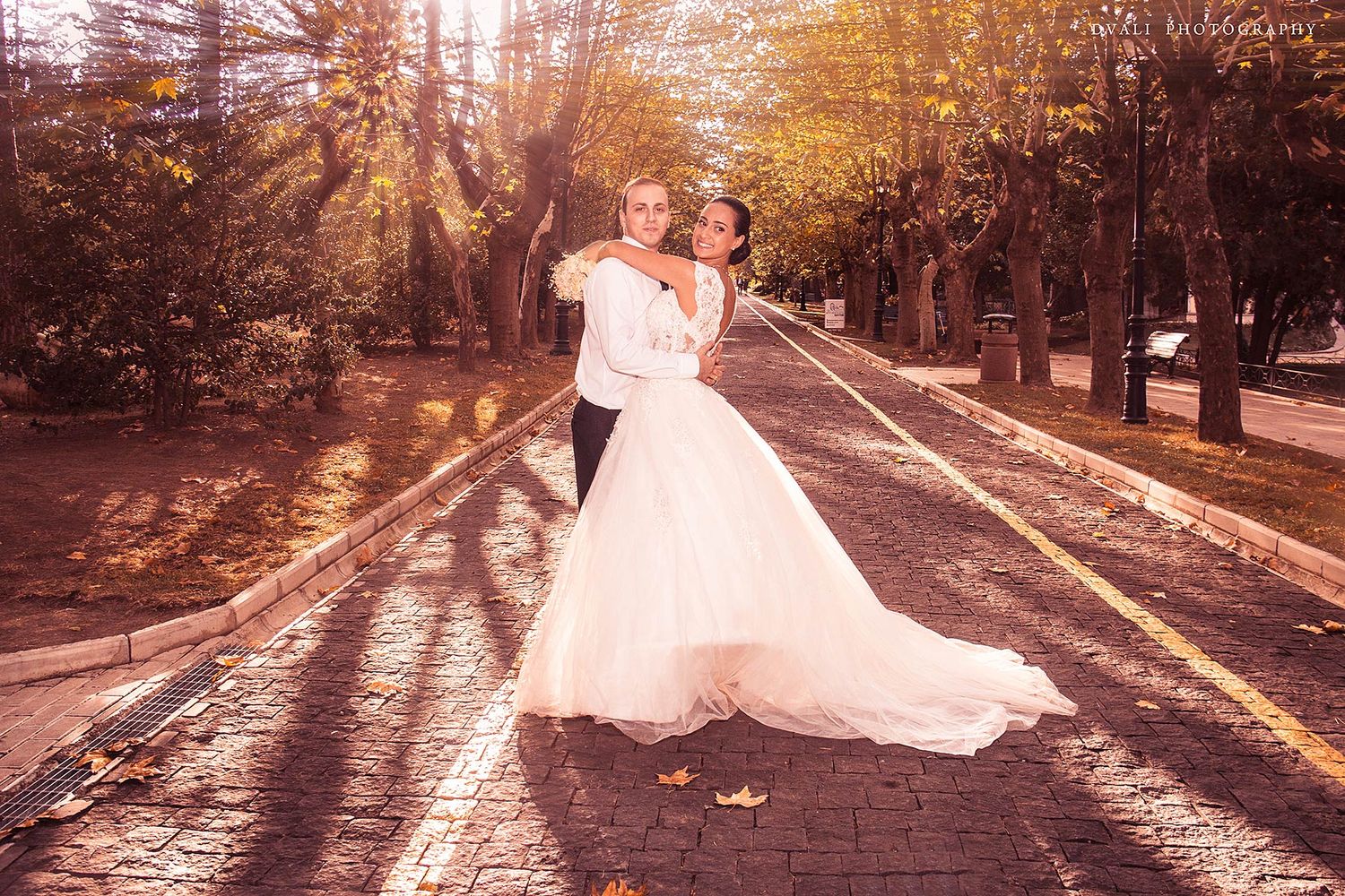 Sunset wedding photography session with golden light streaming through trees.
