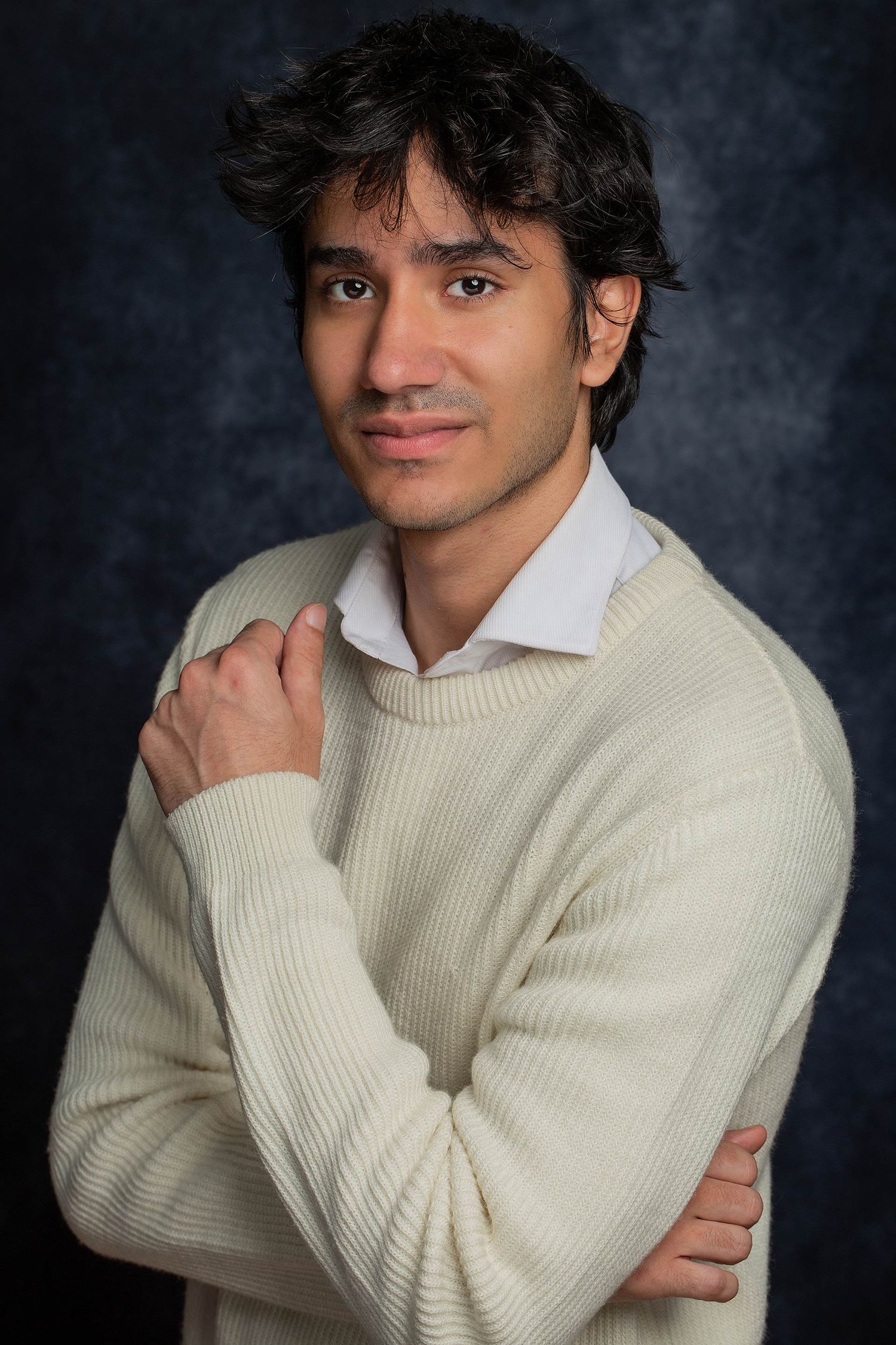 Portrait series featuring casual poses in cream sweater against studio background.