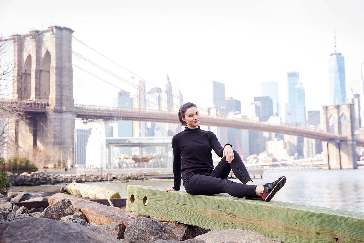 Urban photoshoot with Brooklyn Bridge and NYC skyline in background.