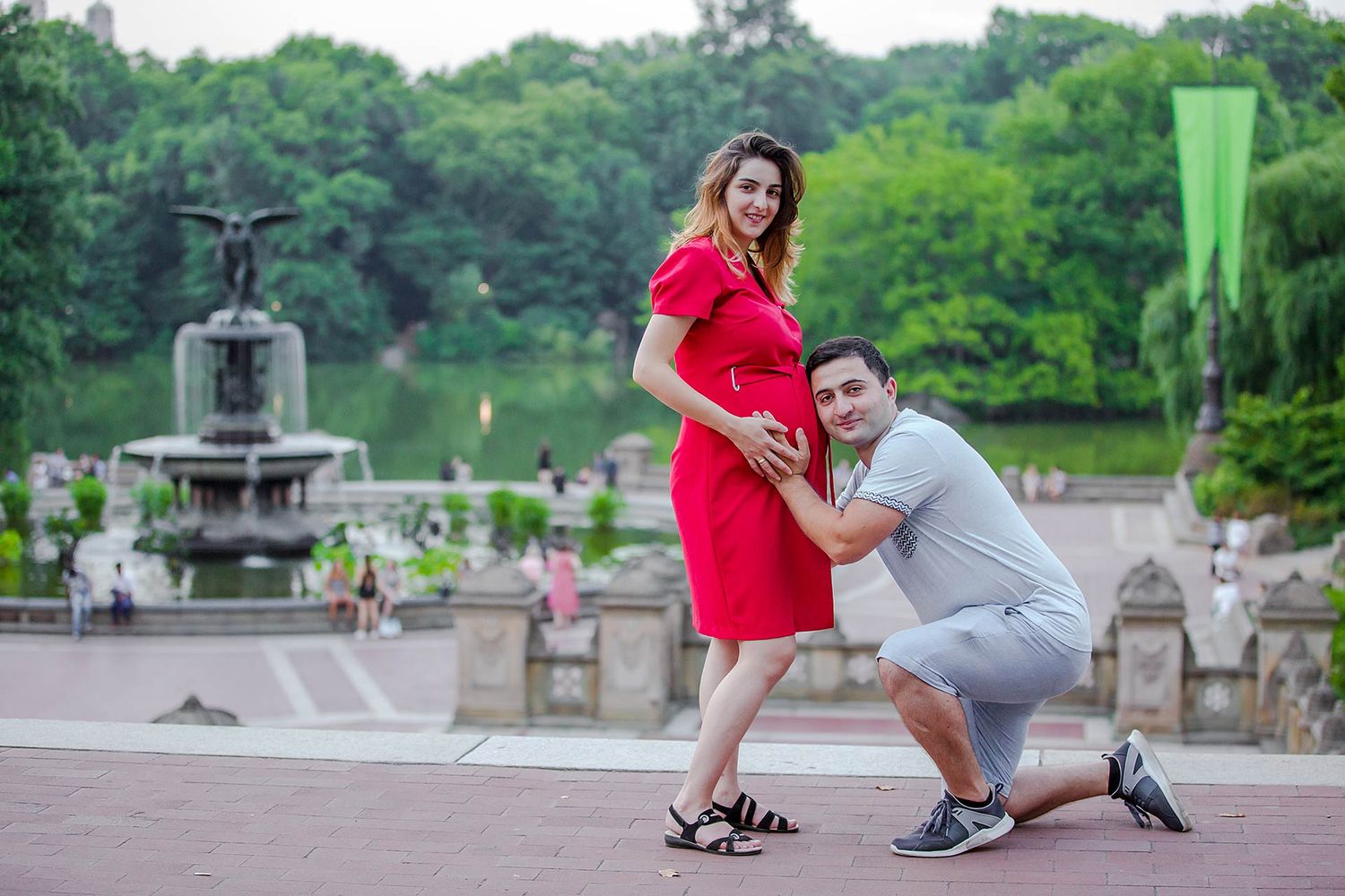 Romantic engagement photoshoot in Central Park with fountain backdrop.