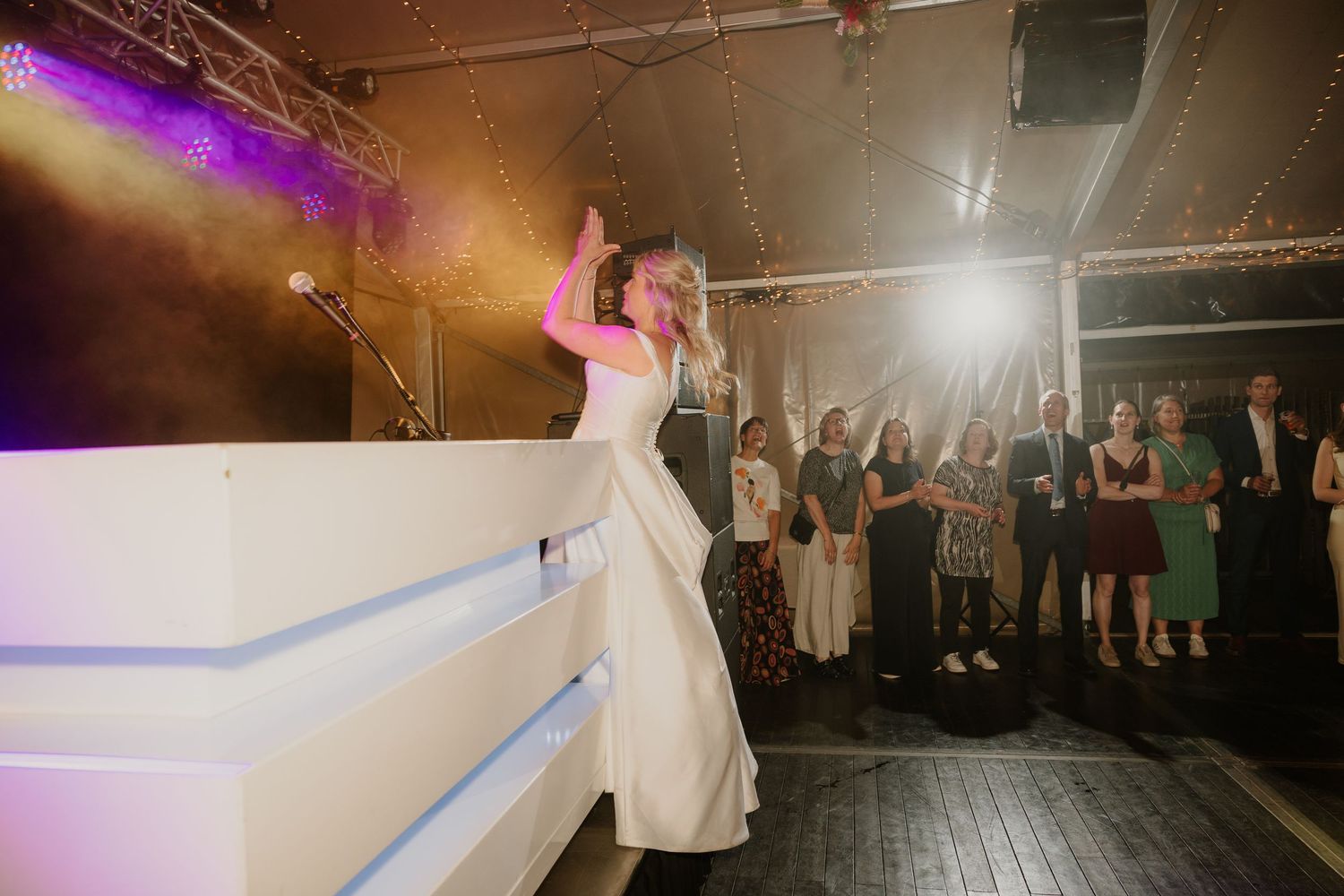 Bruid gooit haar bloemen naar de vrijgezelle dames tijdens het avondfeest