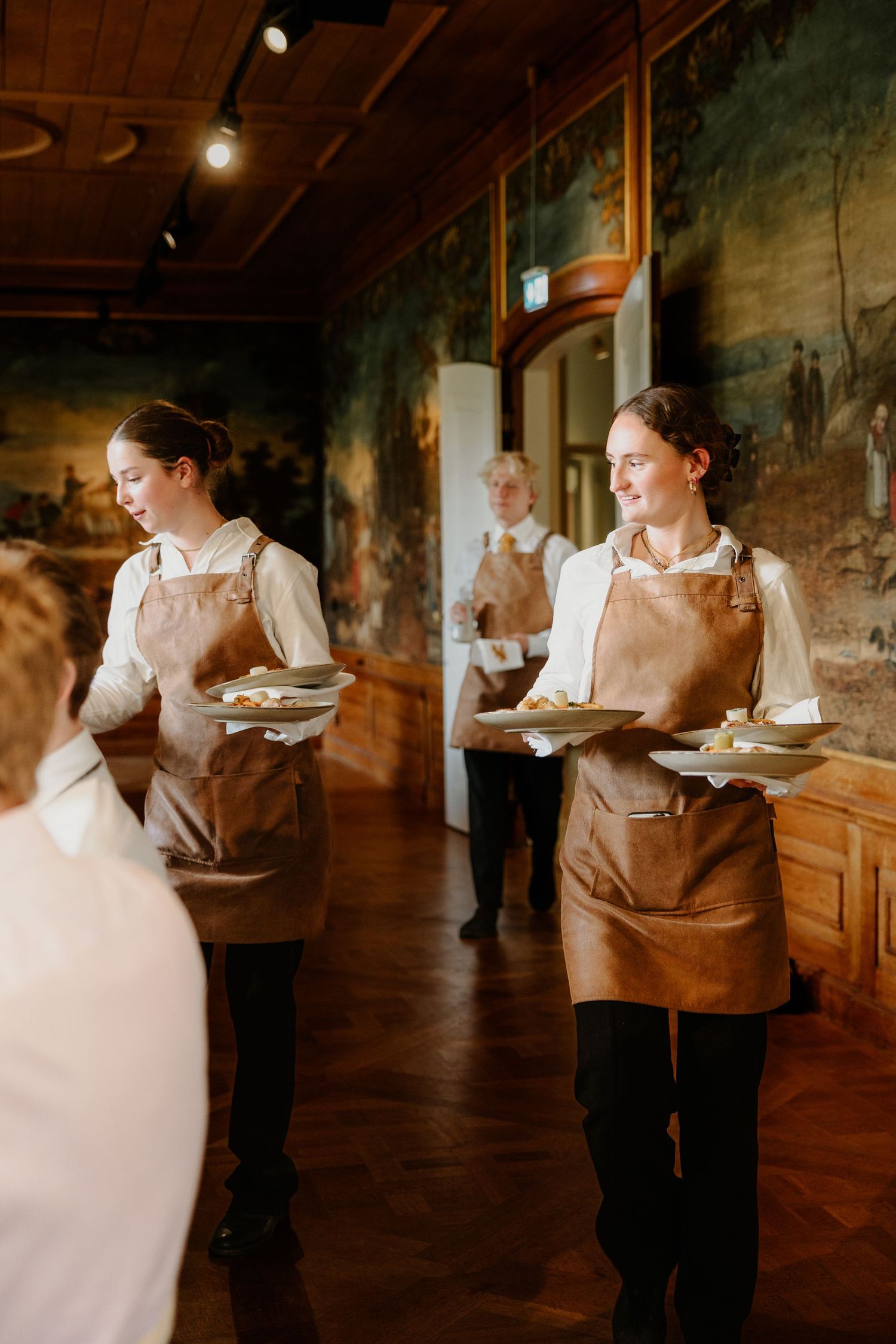 Bediening serveert gerechten tijdens het diner op een bruiloft