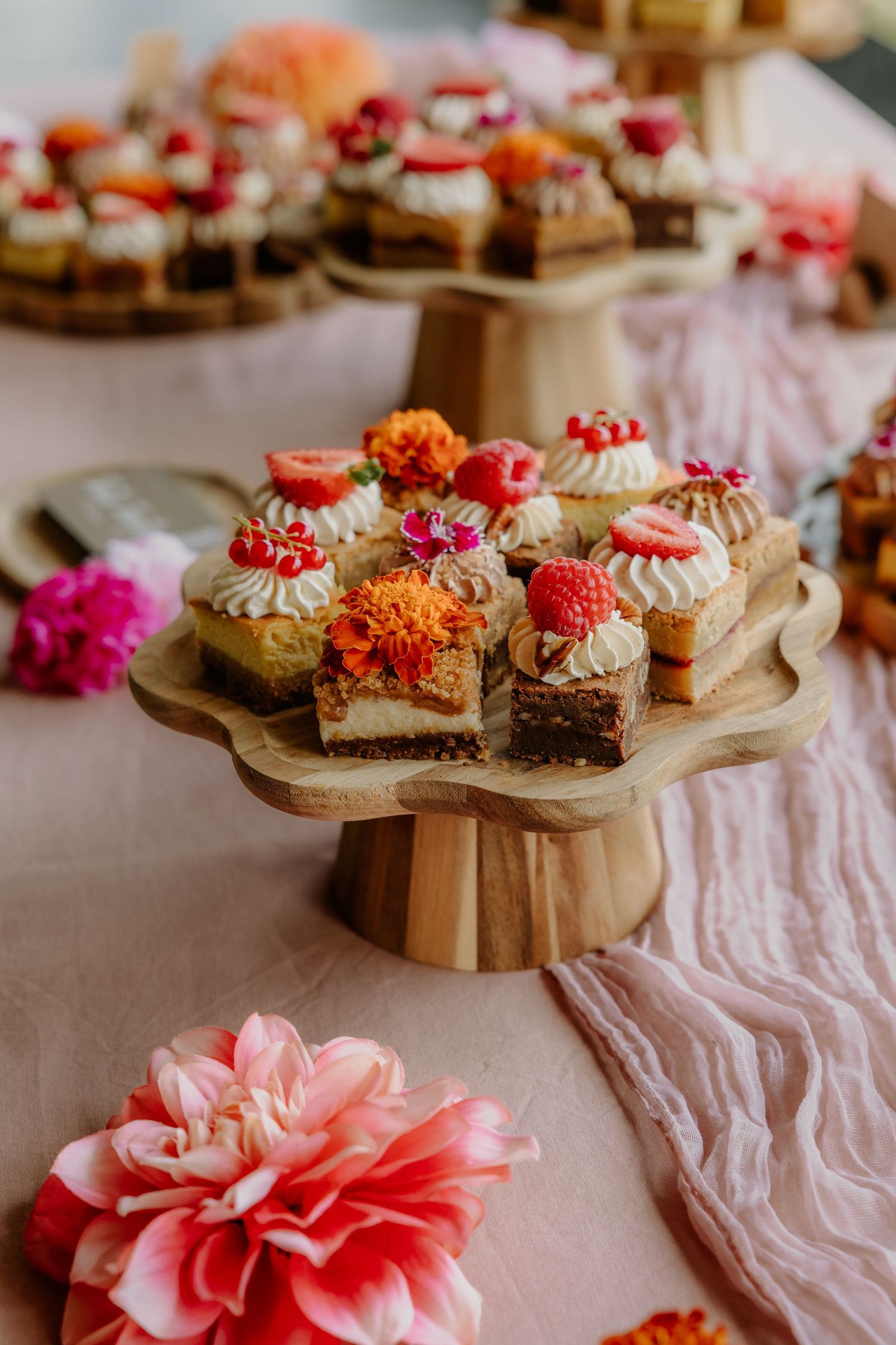 Kleurrijke bruidstaartjes en gebak op een feestelijk gedekte sweet table